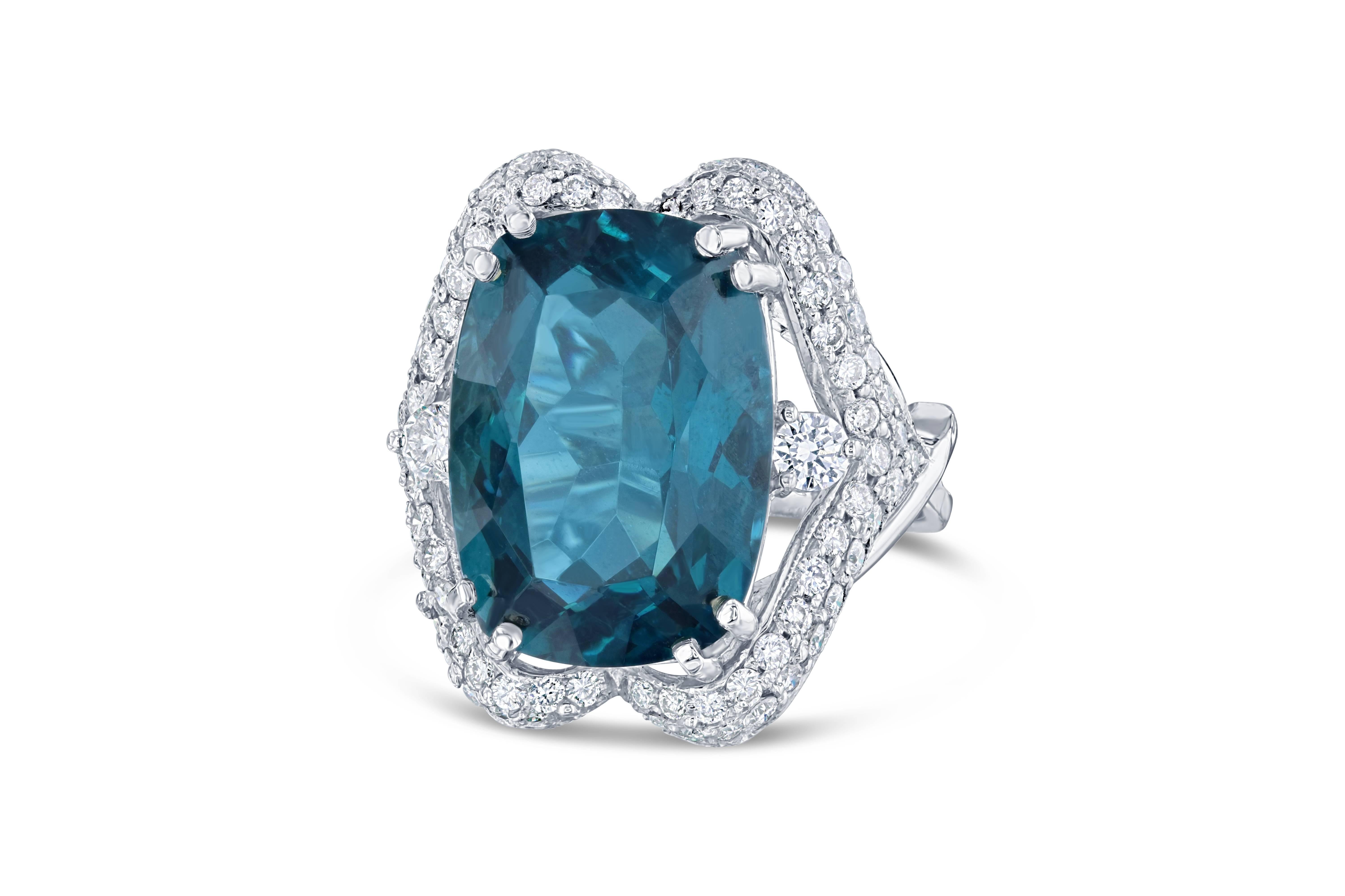 This ring has a large and gorgeous 15.26 carat Apatite in the center of the ring and is surrounded by 81 Round Cut Diamonds that weigh 1.30 carats Clarity: VS2, Color: F.  The total carat weight of the ring is 16.56 carats.  The ring is made in 18K