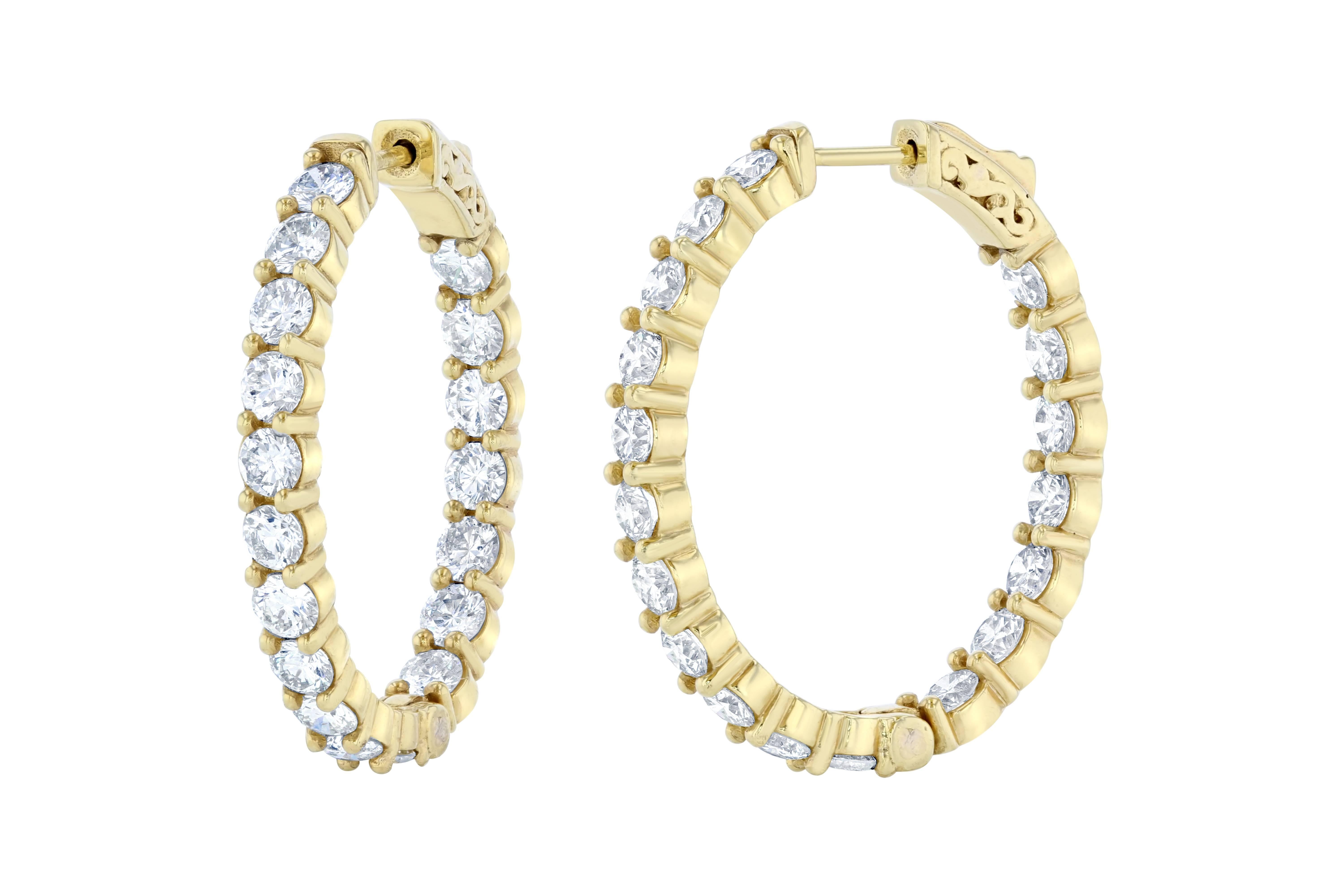 These stunning diamond hoops have diamonds set inside and out to give the piece symmetry and sparkle from all angles.  There are 36 Round Cut Diamonds that weigh 6.75 carats and they are made in 14K Yellow Gold and weigh approximately 13.4 grams.