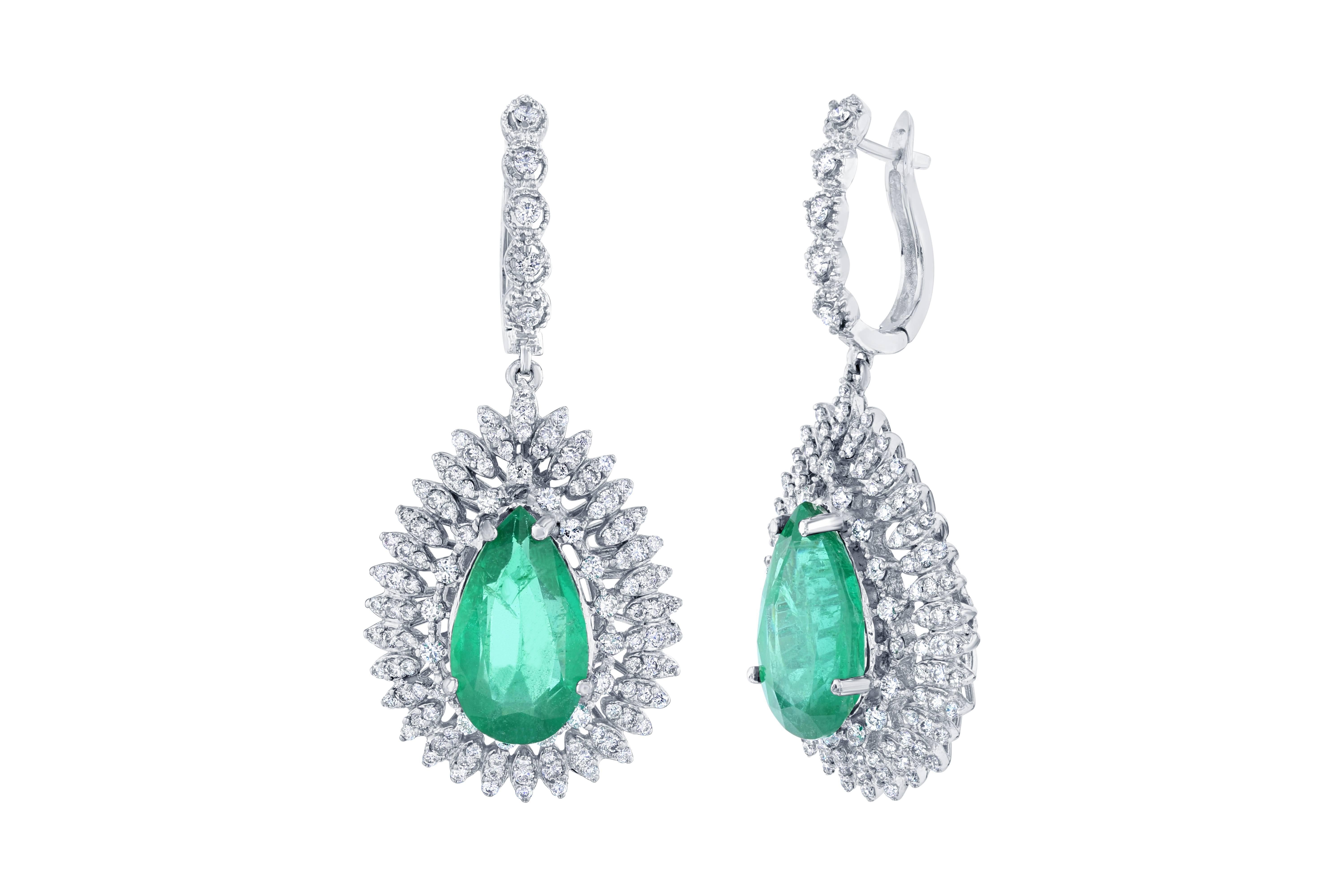 One of a kind masterpiece!!  A gorgeous and rare pair of Pear Cut Emeralds are set in the center of the earrings that weigh 10.74 carats.  The Emeralds are mined in Zambia.  The Emeralds are surrounded by 236 Round Cut Diamonds that weigh a total of