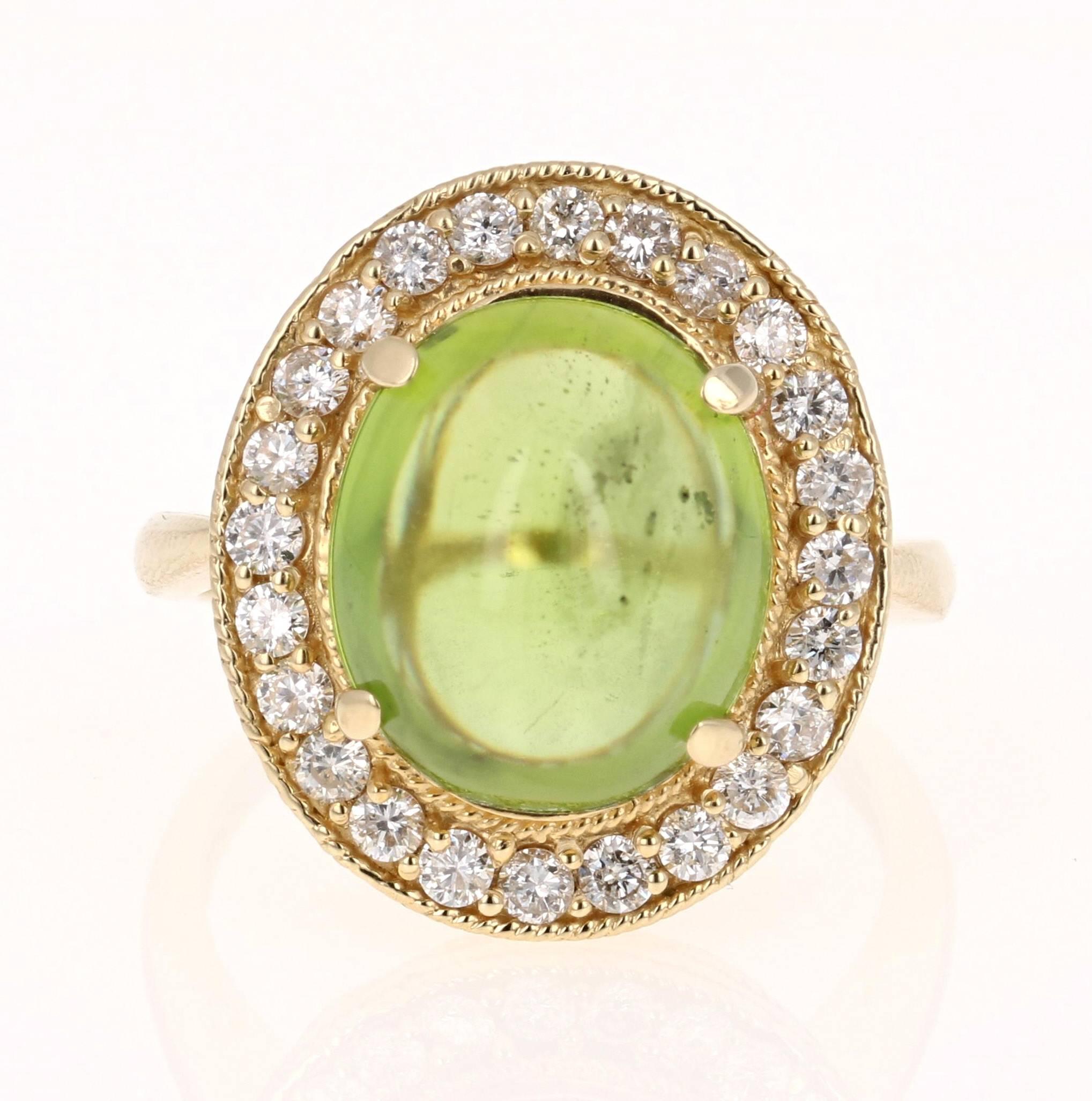This beautiful ring has a large Oval Cabochon Cut Peridot in the center that weighs 7.11 carats. The ring is surrounded by a gorgeous halo of 24 Round Cut Diamonds that weigh 0.70 carats. The total carat weight of the ring is 7.81 carats. The
