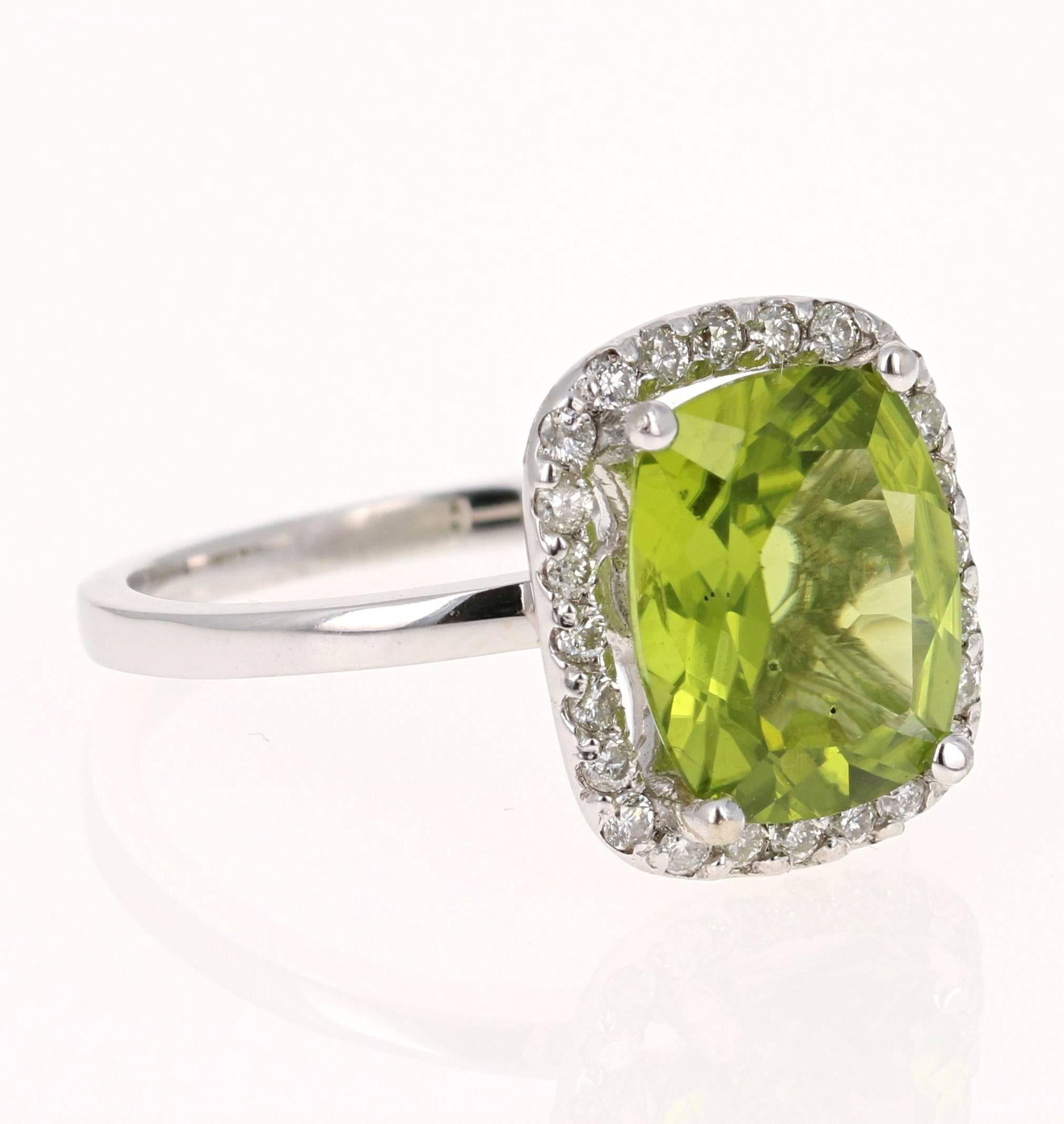 This beautiful ring has a Cushion Cut Peridot in the center that weighs 3.67 carats. The ring is surrounded by a gorgeous halo of 24 Round Cut Diamonds that weigh 0.37 carats. The total carat weight of the ring is 4.04 carats. The setting is crafted
