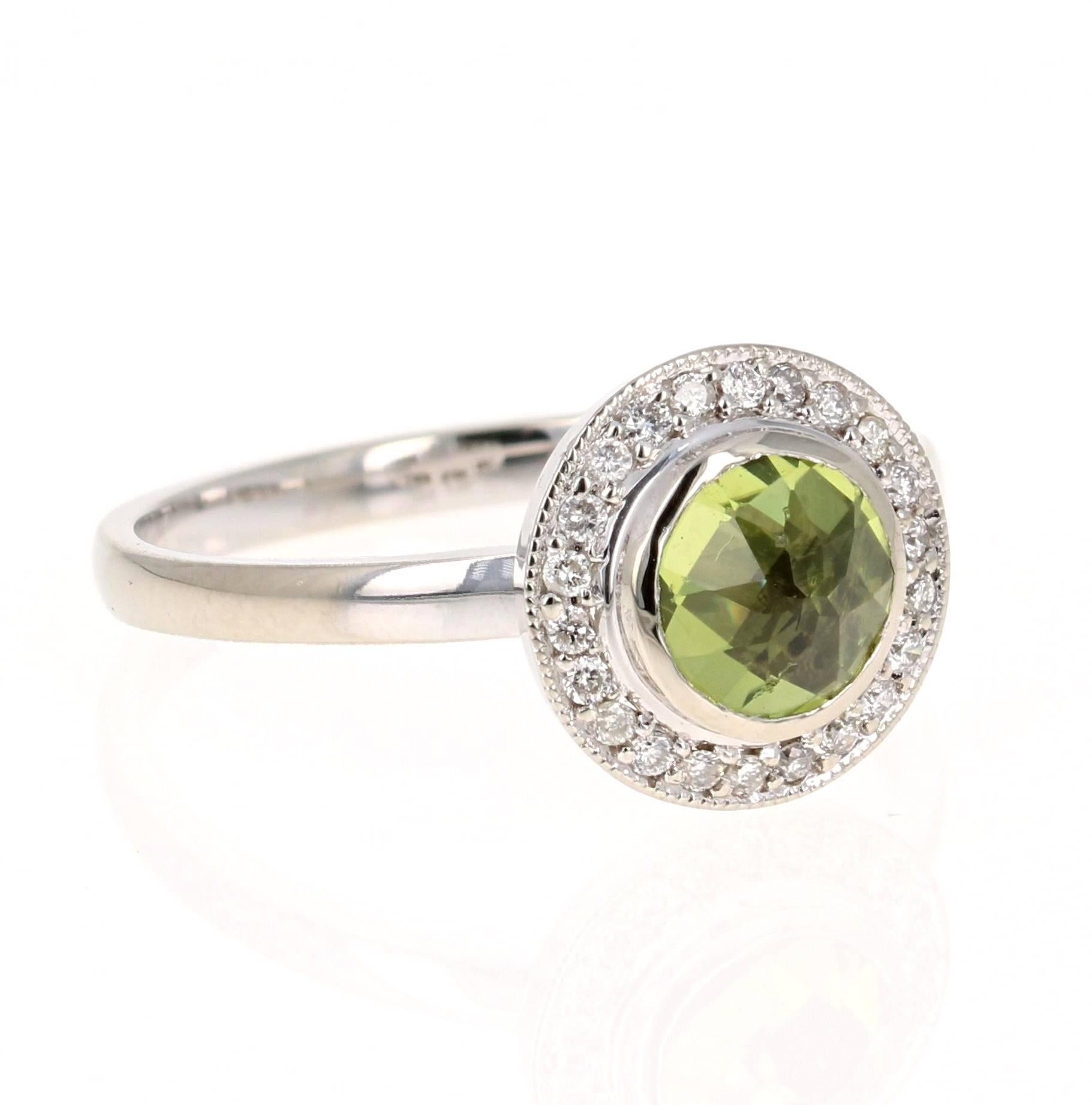 This beautiful ring has a Round Cut Peridot in the center that weighs 0.89 carats. The ring is surrounded by a cute halo of 22 Round Cut Diamonds that weigh 0.14 carats. The total carat weight of the ring is 1.03 carats. The setting is crafted in