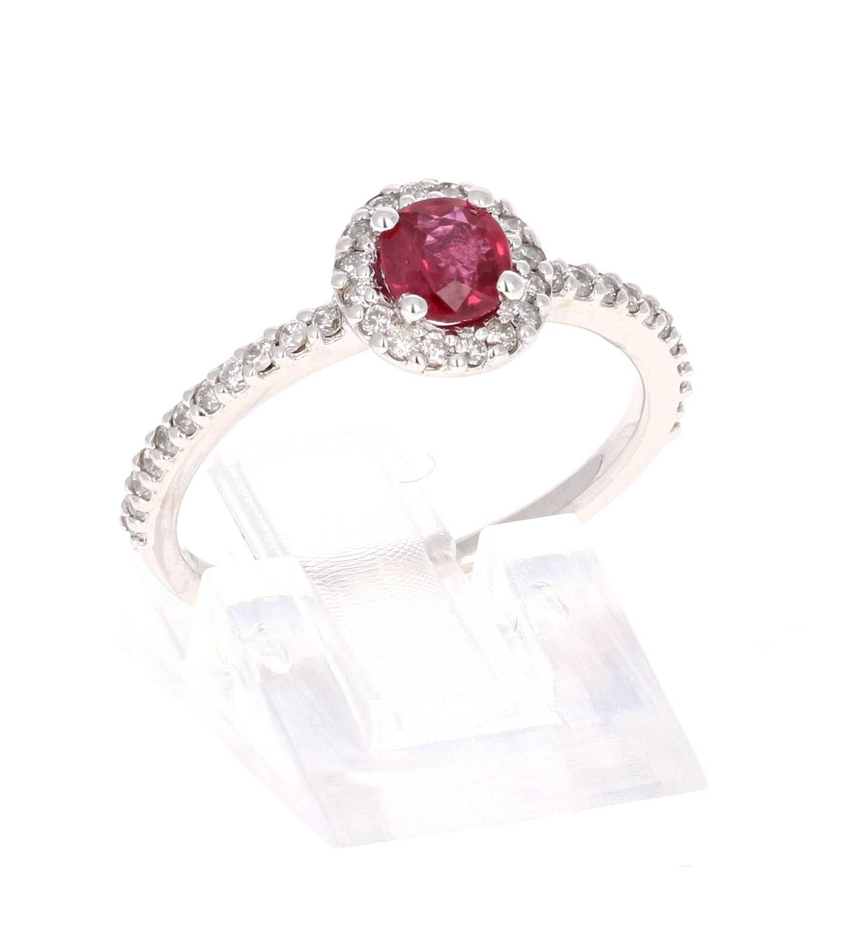 This elegant and dainty Ruby Diamond Ring can be a modern Engagement/Promise ring. It has a natural Burmese Ruby that is 0.60 Carats with a flow of 38 Round Cut Diamonds weighing 0.37 Carats. It is set delicately in 14K White Gold and is a ring size