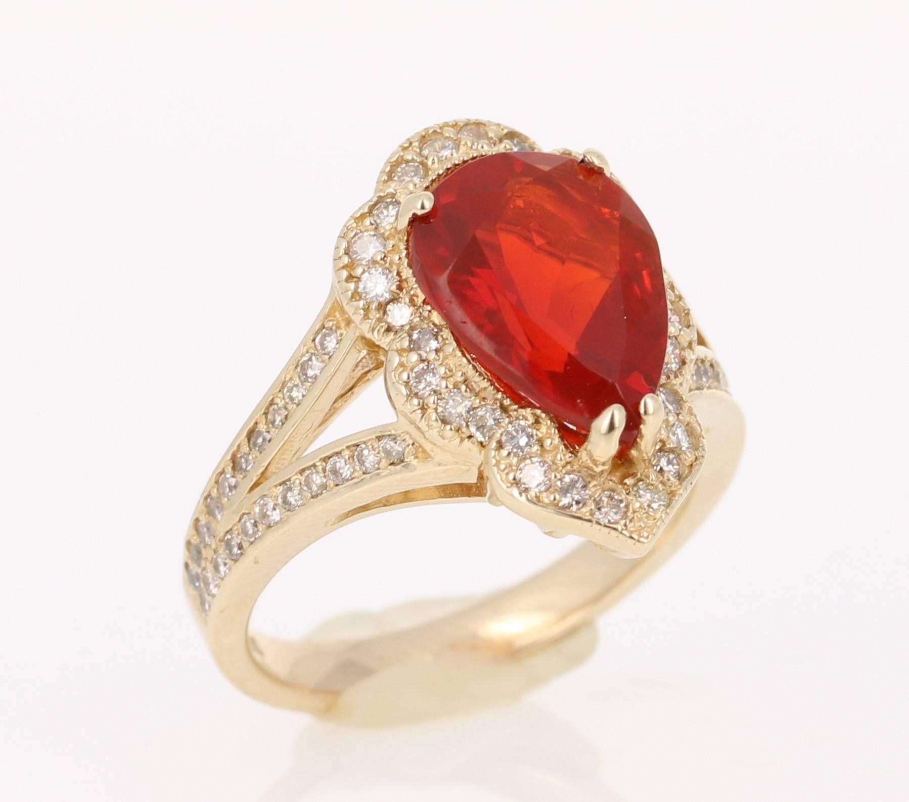 This gorgeous ring can totally be an engagement ring for someone that wants to dip into something a bit edgy and different.  It has a beautiful Pear Cut Fire Opal that weighs 2.65 Carats and 72 Round Cut Diamonds that weigh 0.60 Carats. The clarity