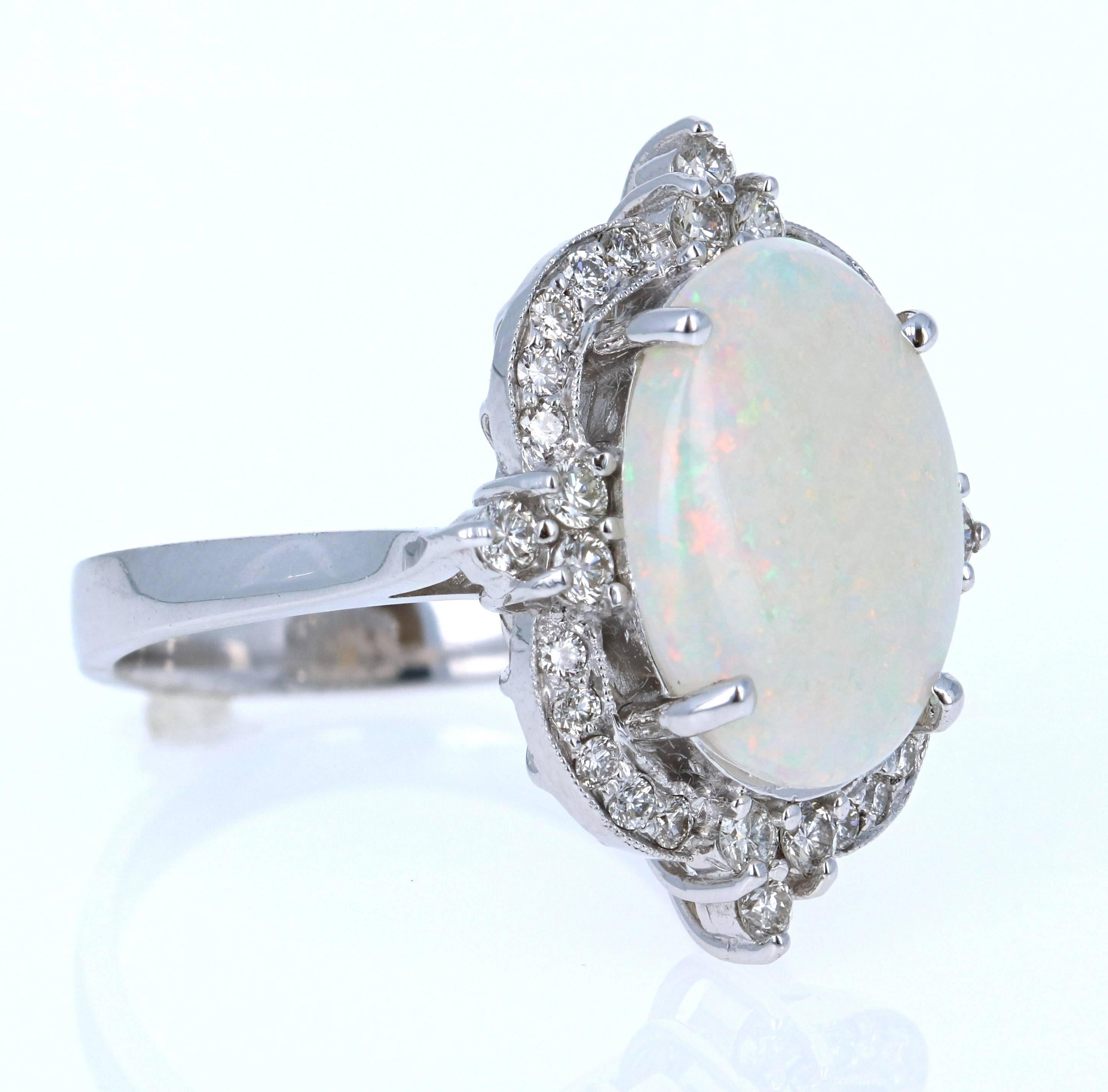 Stunning Opal and Diamond Ring made in a 14K White Gold setting.  The Oval Cut Opal in this Ring weighs 4.02 carats and is surrounded by 32 Round Cut Diamonds that weigh 0.71 carat (Clarity: VS, Color: H).  The total carat weight of this ring is