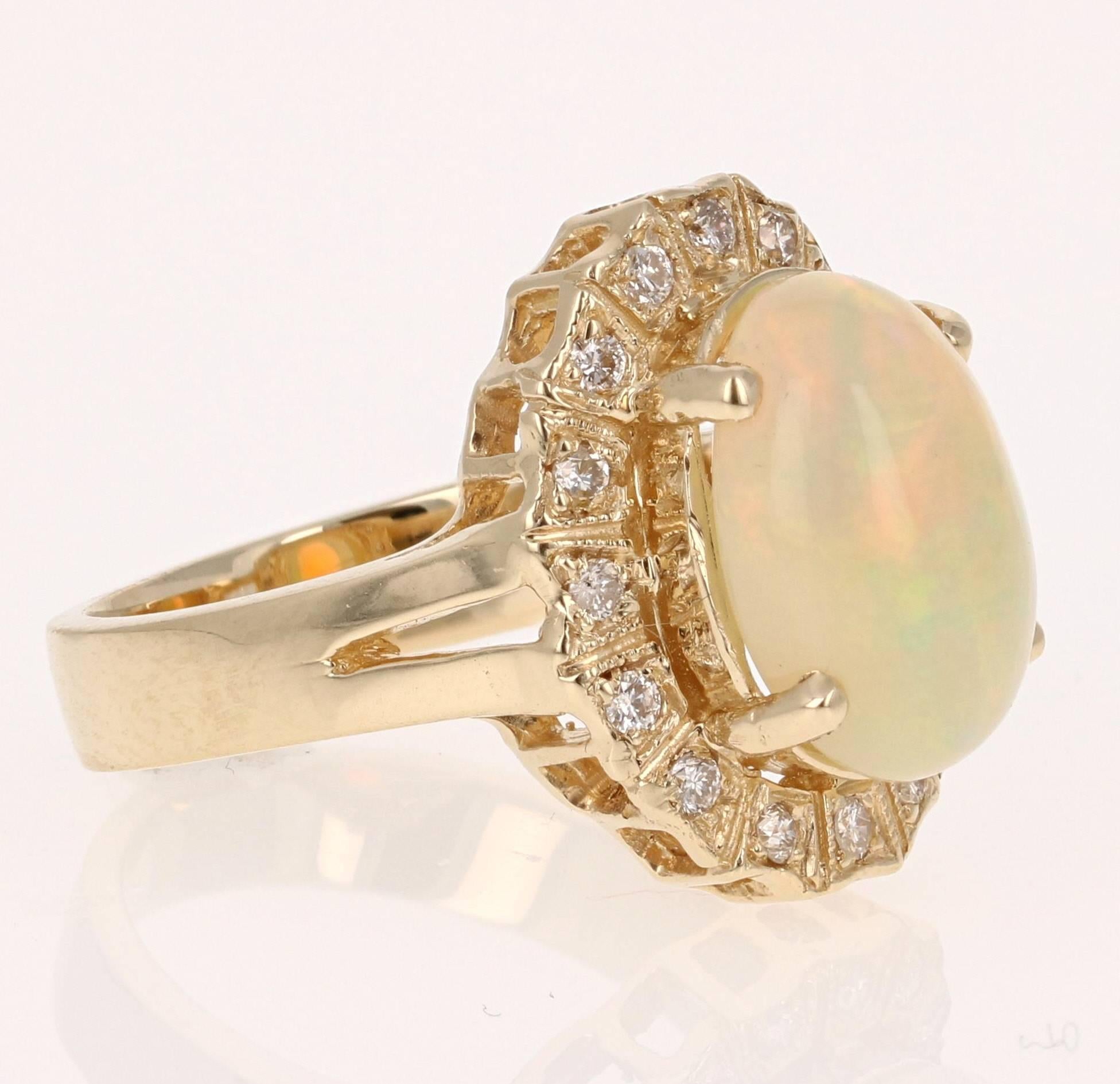 Stunning Opal and Diamond Ring made in a 14K Yellow Gold setting.  The Oval Cut Opal in this ring weighs 3.36 carats and is surrounded by 16 Round Cut Diamonds that weigh 0.27 carat.  The total carat weight of this ring is 3.63 cts.  The ring is a