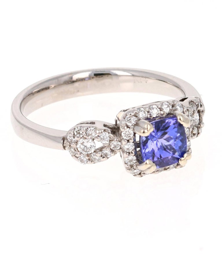 This cute and pretty Tanzanite Diamond Ring has a 0.79 Carat Square Cushion Cut Tanzanite as its center stone and has 35 Round Cut Diamonds that weigh 0.31 Carats. The Total Carat weight of the ring is 1.10 Carats.
 It is delicately crafted in 14K