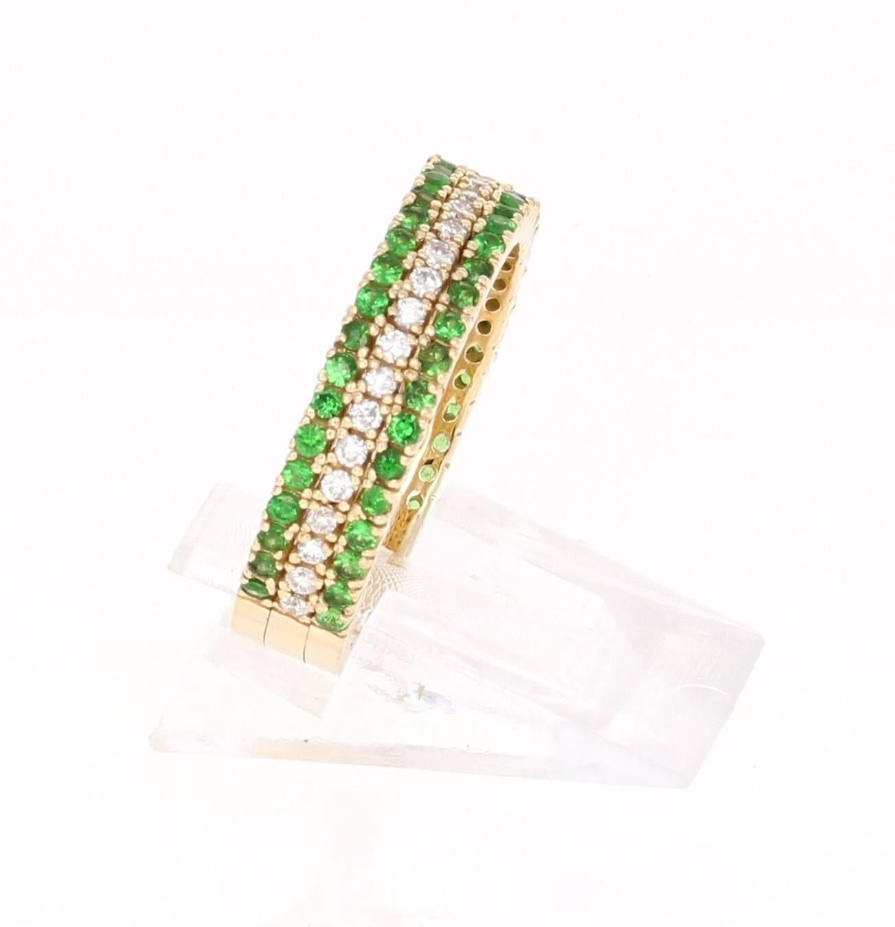 A cute and dainty Tsavorite and Diamond Band that is sure to be a great addition to your jewelry collection.  This band has 2 rows of Tsavorites and 1 row of Diamonds. There are a total of 60 Round Cut Tsavorites that weigh 0.67 carats and 30 Round