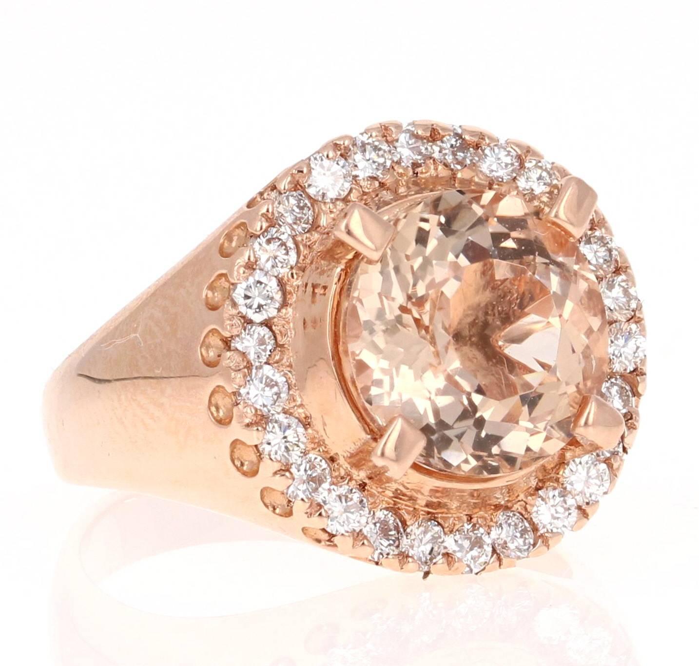 14K Rose Gold Ring that has a beautiful Round Cut Morganite that weighs 3.96 Carats. The Morganite is surrounded by 26 Round Cut Diamonds which weigh 0.65 Carats. The ring is a size 7, and can be re-sized at no additional charge, if needed. 