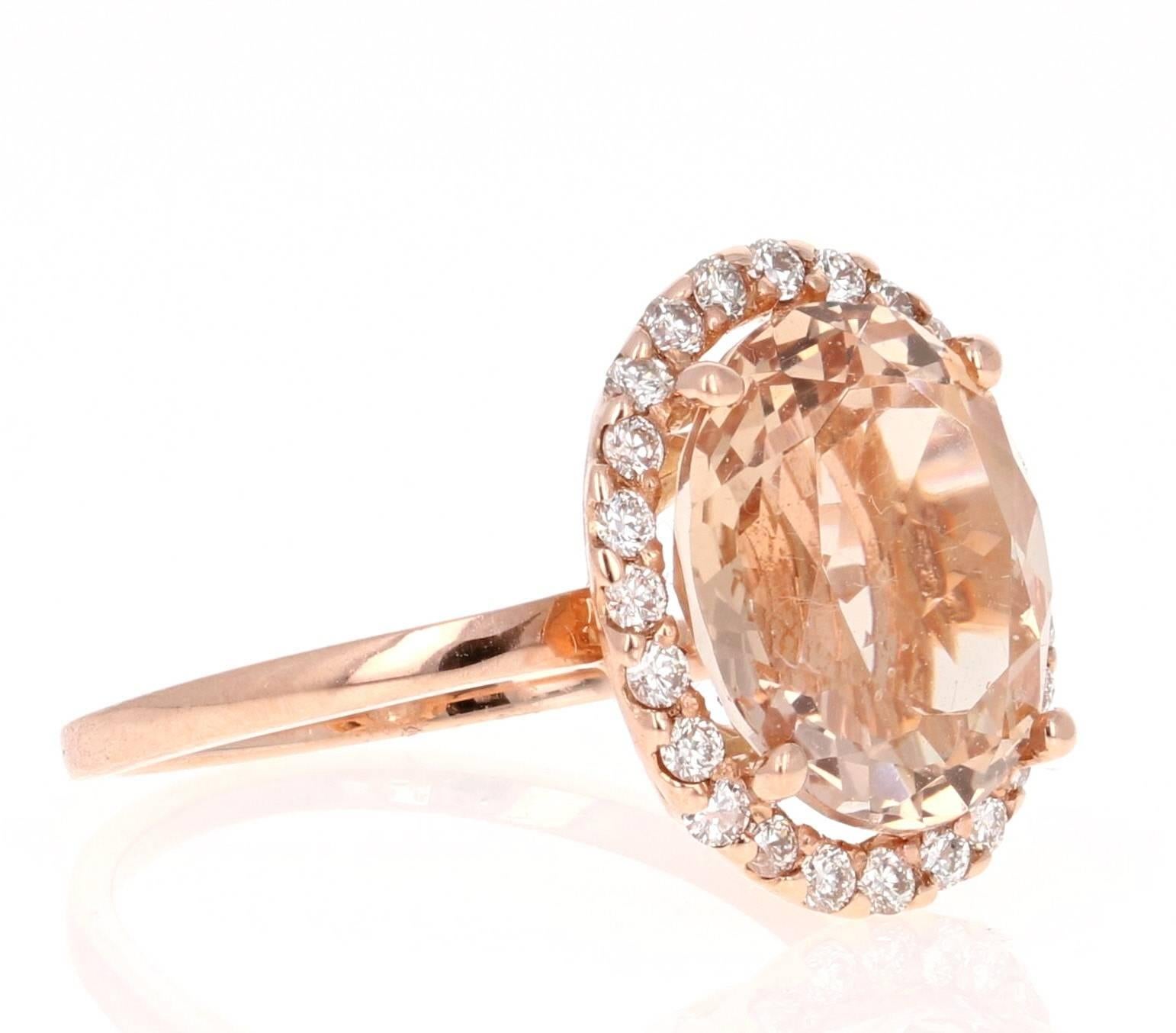 This classic Morganite Ring has a Oval Cut 5.26 Carat Morganite as its center and is surrounded by a halo of 24 Round Cut Diamonds that weigh 0.40 Carats. The clarity and color of the diamonds are VS-H. 
It is set in 14K Rose Gold and is a size 7