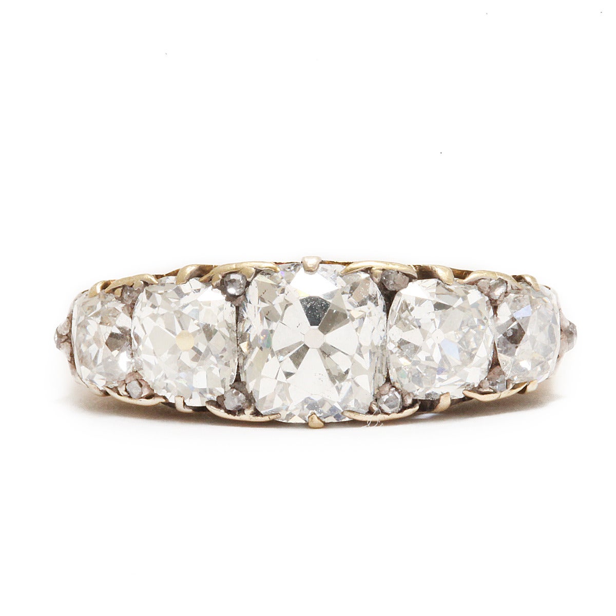 Victorian old-mine diamond half-hoop five-stone ring set in carved gold.

English, ca. 1890
(approx. 3.2 cts)