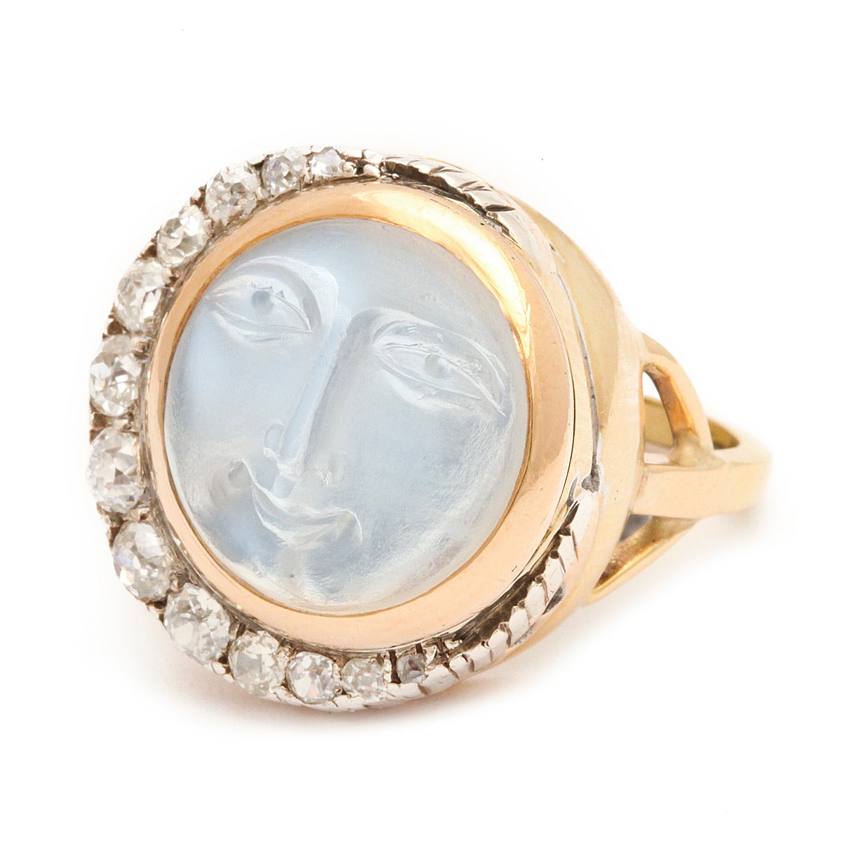Carved moonstone man in the moon ring with an old-mine diamond crescent moon, set in silver and gold.

English, mid to late 19th century