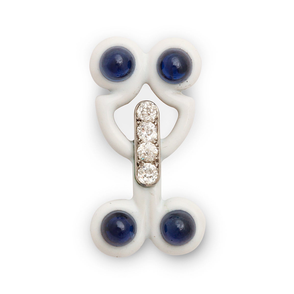 White enamel, cabochon sapphire, and diamond fantasy pin. 

Cartier, Paris ca. 1920