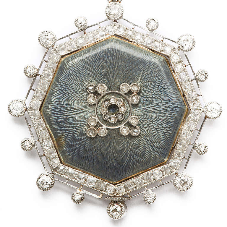 Natural pearl, diamond, and platinum chain, suspending a guilloché enamel and diamond watch.

By Tiffany & Co., ca. 1915
Length: 23 in.
Drop: 4 1/4 in.