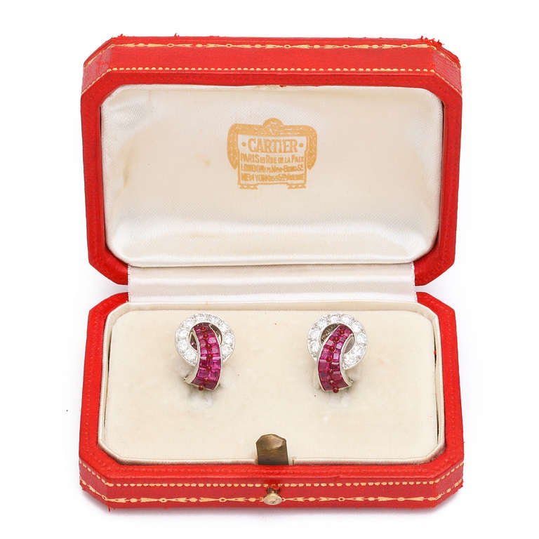 Pair of Art Deco invisibly-set ruby and diamond clip earrings mounted in platinum. In original Cartier box.
