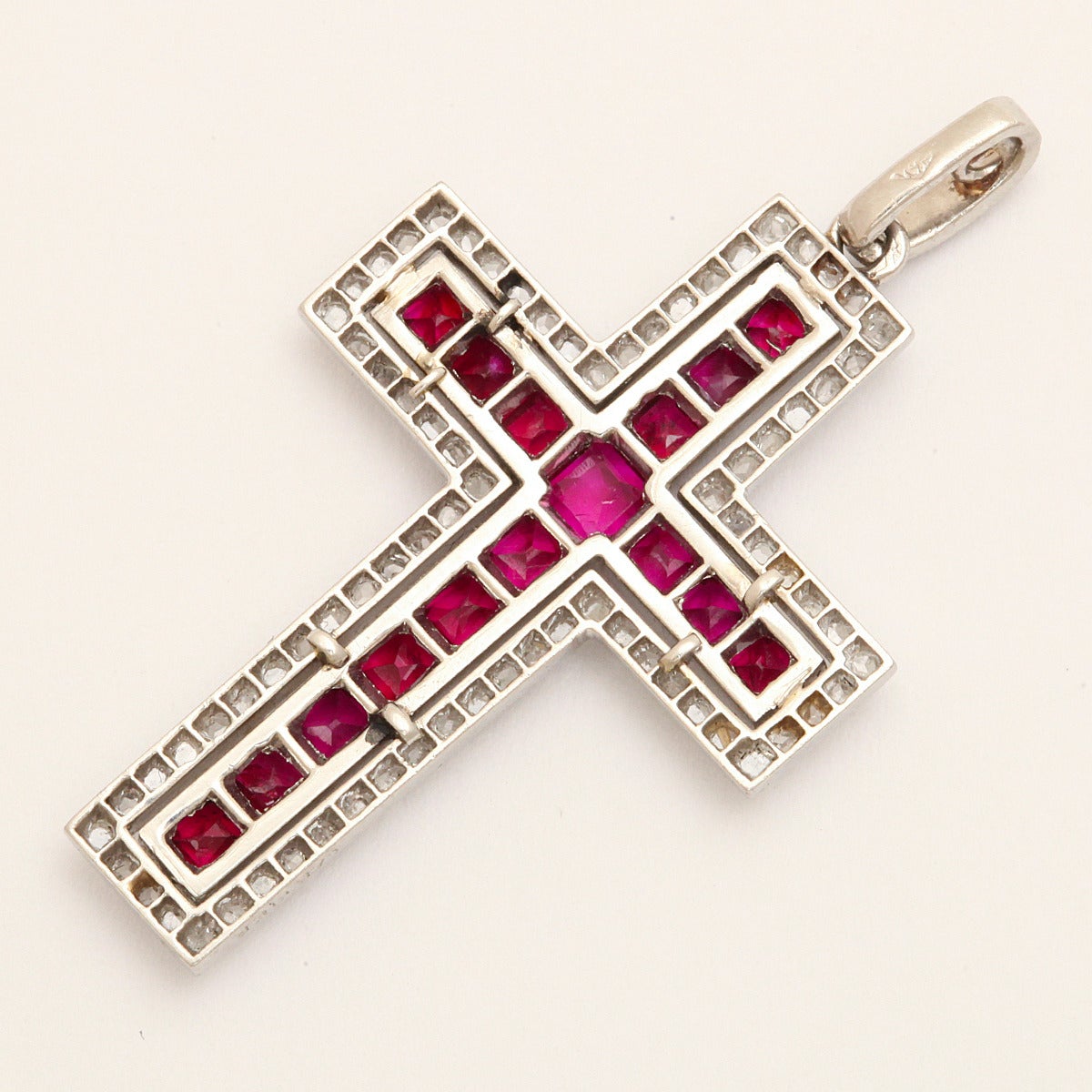 Ruby and diamond cross pendant set in platinum, with diamond bail.

By Cartier, New York, ca. 1930
Length: 1 3/8 inches
(rubies approx. 1.6 cts, diamonds approx. 1.5 cts)