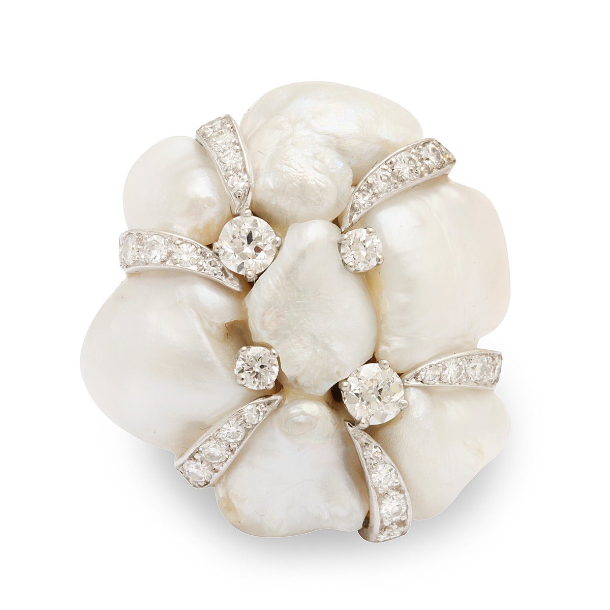 Vintage natural baroque pearl clasp set in platinum with diamonds. Contemporary mount converts it into a ring. Jeweler to the stars, William Ruser, was renowned for his monumental and fantastical pearl creations.