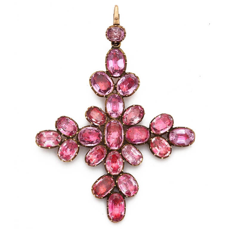 Foiled pink topaz Maltese cross pendant, set in gold.

Lady Emma Hamilton set the trend for Maltese crosses in the early nineteenth-century. She received one from Russian Emperor Paul I in 1800 and frequently wore it to balls and other events, and