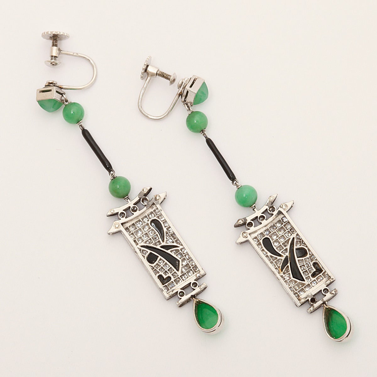 Art Deco jade, diamond, onyx and black enamel dangling Chinese lantern style earrings set in platinum.

French, ca. 1920
Length: 2 1/2 in.