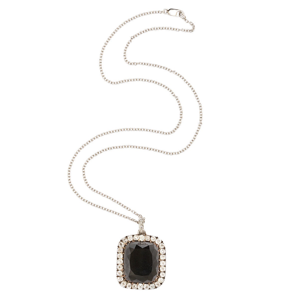 Black diamond and old-mine diamond cluster pendant set in platinum and gold.

English, ca. 1890.
Length: 1 inch (excl. bail)
(Black diamond 37 cts)