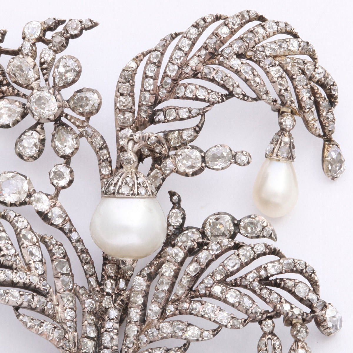Late eighteenth century natural pearl and diamond spray brooch, with four drop pearls and diamond swags, mounted in silver. Probably from the Russian Crown Jewels.

Length: 3 1/4 inches
(Approx. 11.5 cts.)