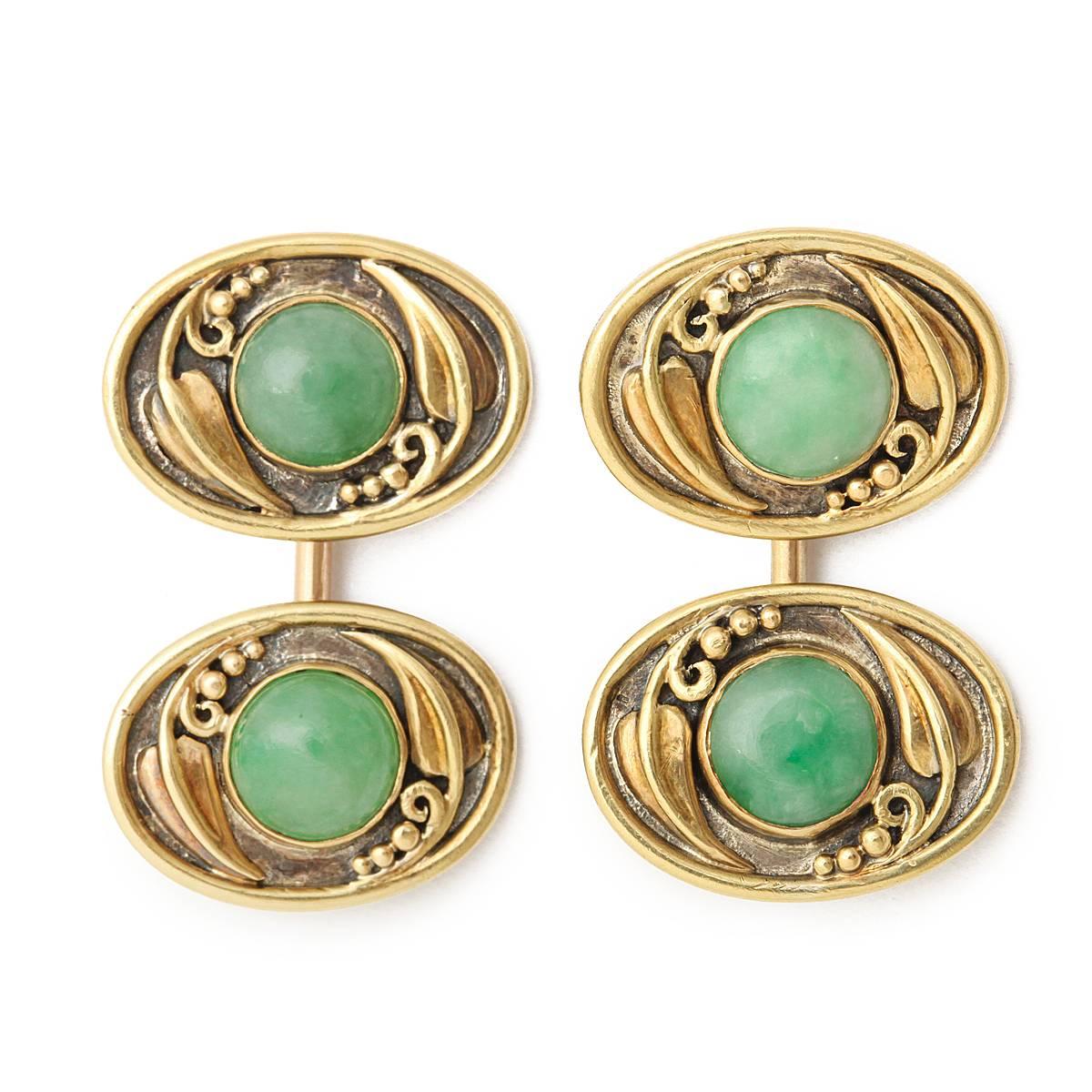 Arts and Crafts oval cabochon jadeite double cufflinks, set in gold and silver.

By F. G. HALE, American, ca. 1910

Frank Gardner Hale worked as a book and music cover designer in Boston before joining the Guild of Handicraft with C. R. Ashbee