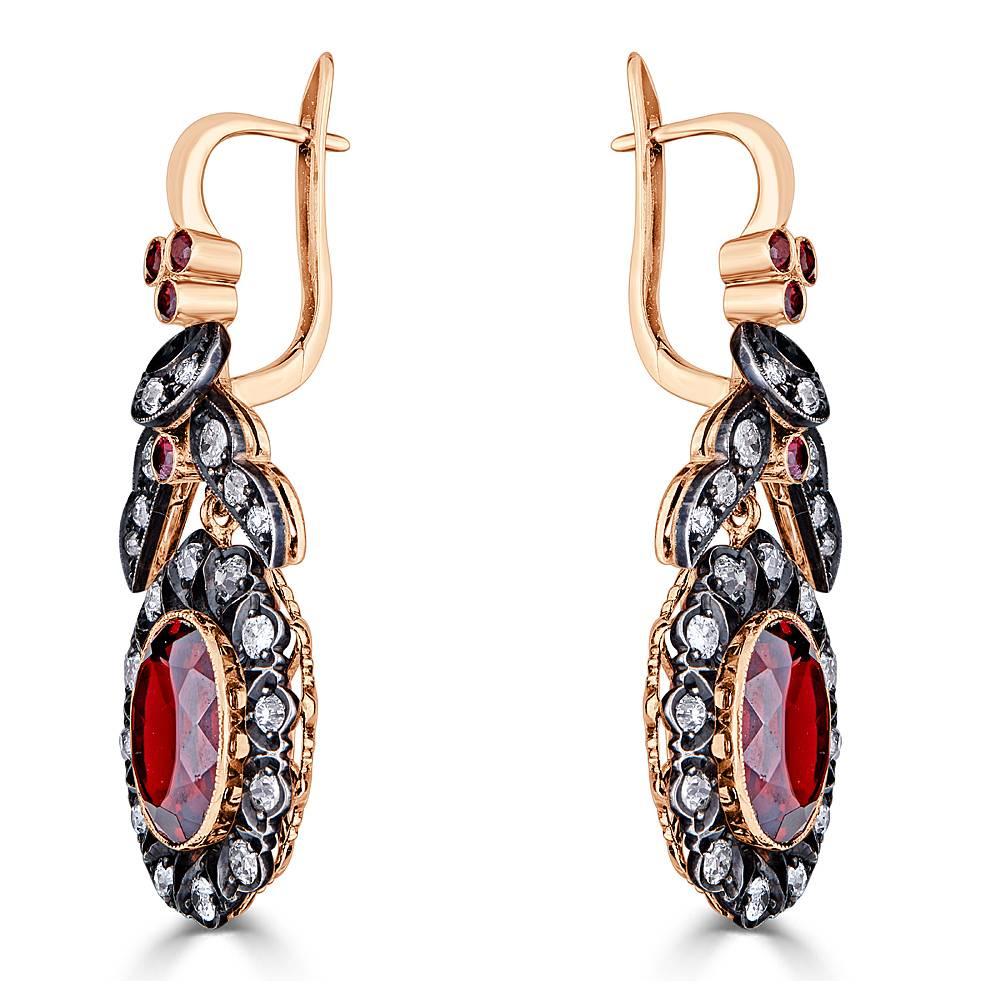 A beautiful pair of estate Garnet and Old Miner Diamond earrings, handcrafted in 18k Rose gold and Sterling Silver accents that are finished with an antique black patina. These earrings feature 2.60 carats Total of Old Miner White Diamonds with