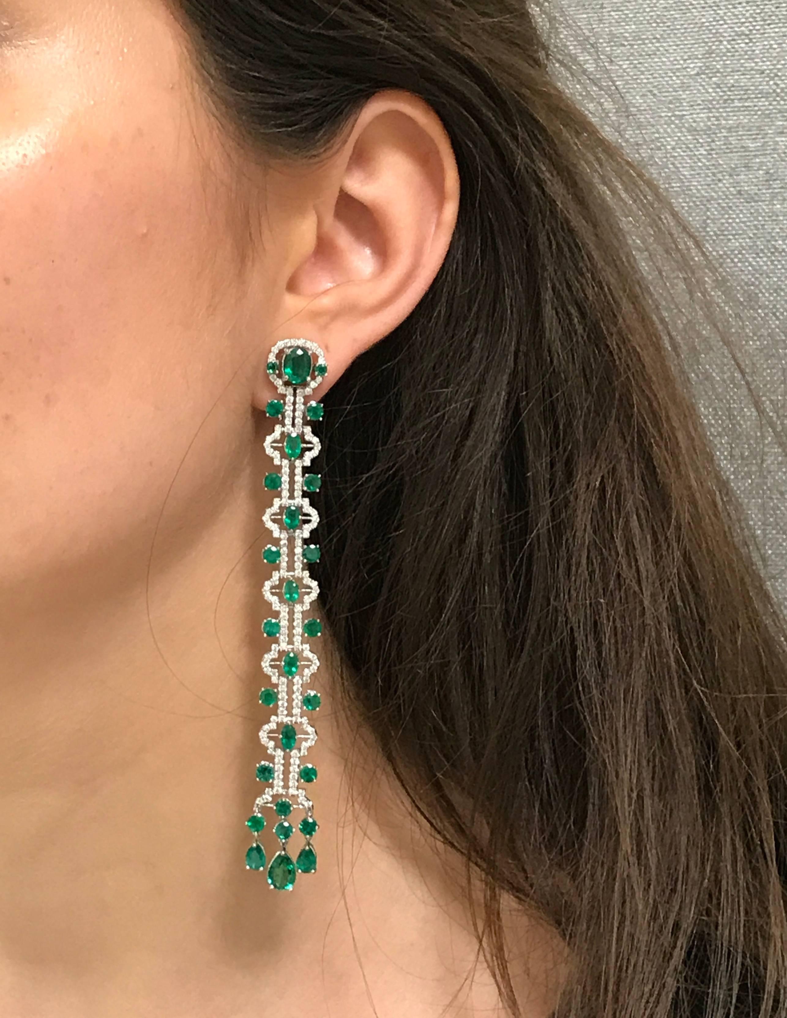 A pair of Line earrings with Beautiful Green Emeralds and pave Diamonds. Handcrafted in 18k white gold and suspended from a hidden post and omega back, these earrings feature 2.45 carats of pave Diamonds and 13.30 carats of Natural Green Emeralds.