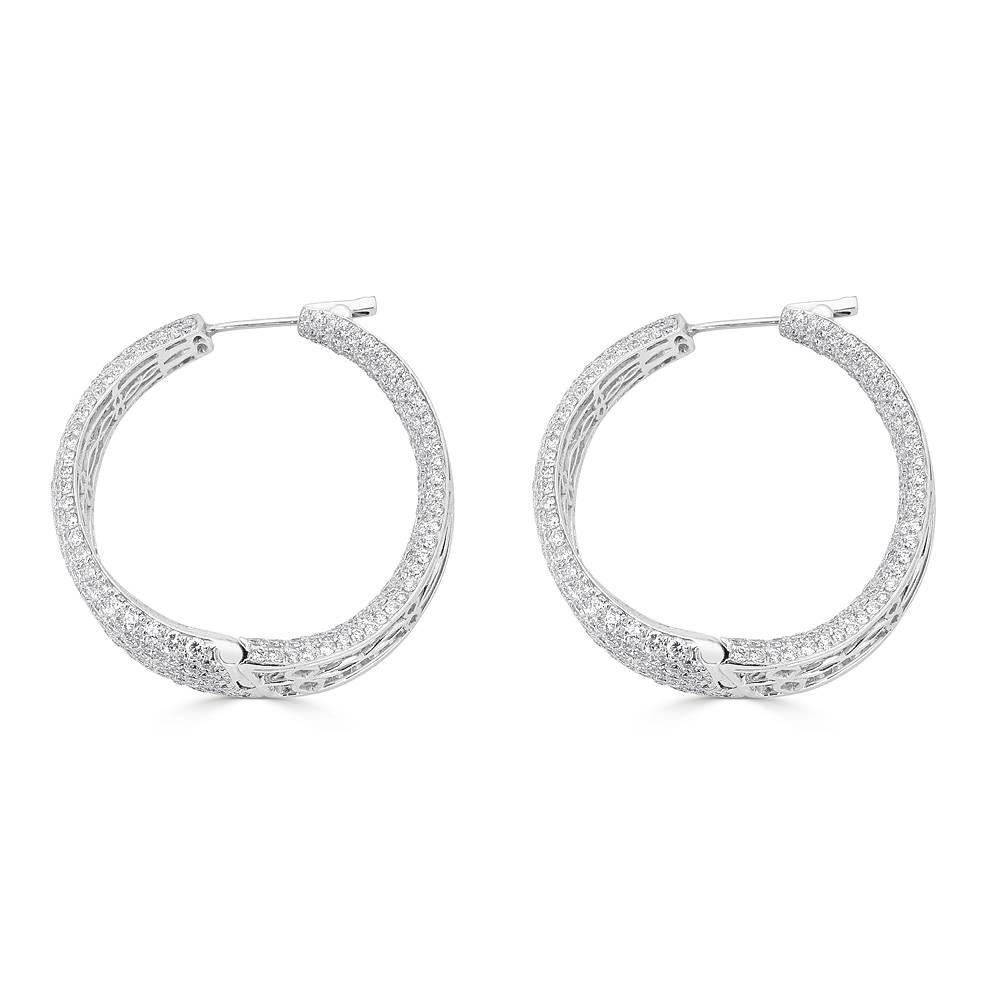 An impressive inside-out pave diamond hoop earrings in a sleek wave shape. Handcrafted in 18k White gold, this particular pair of earrings features 957 pave set full cut diamonds with a total of 17.02 carats. Outstanding color of F/G and clarity of