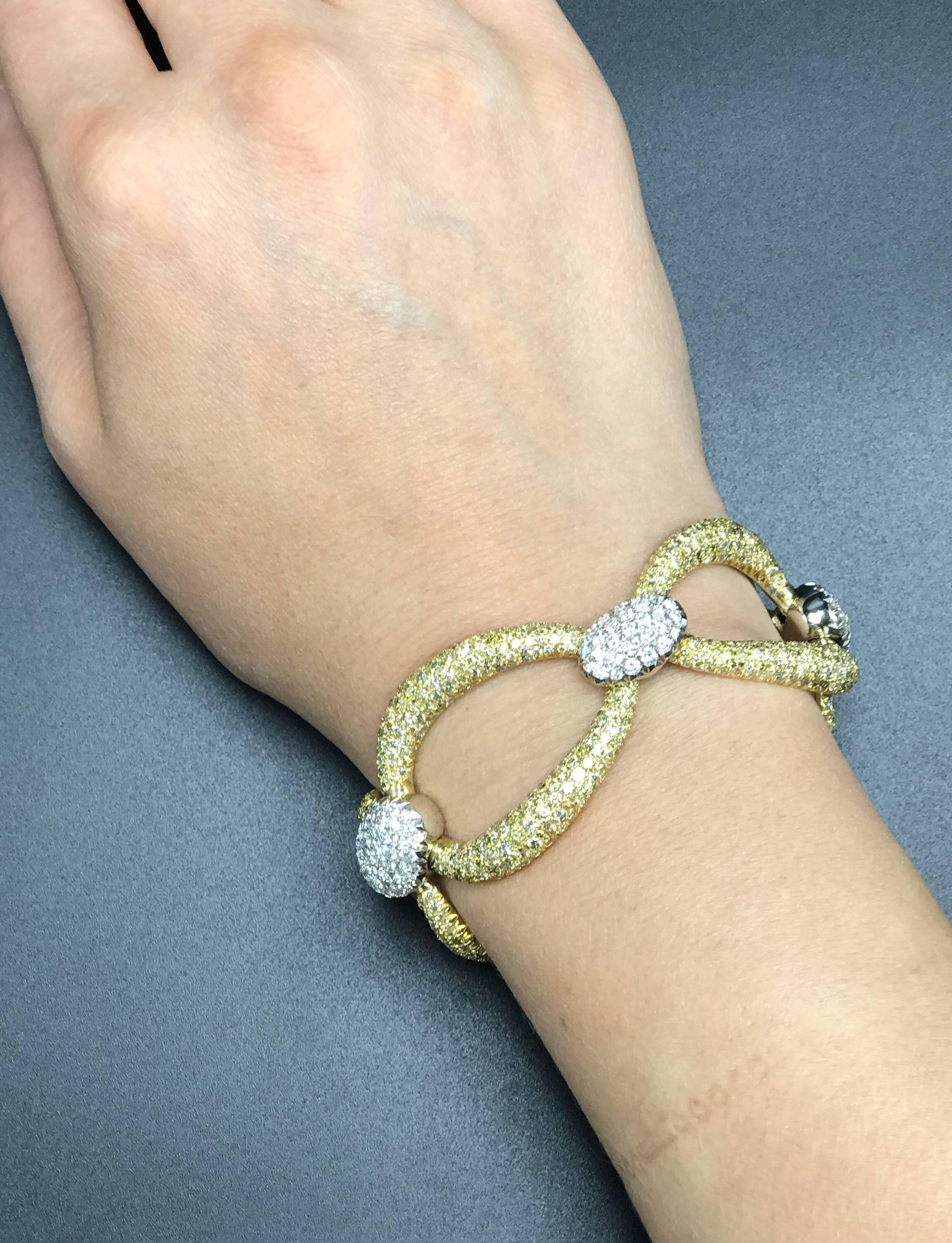 A stunning link bracelet that features both Fancy Color Diamond and Colorless Diamond pave. Handcrafted in 18k White and Yellow Gold, this bracelet is set with 956 Full Cut Fancy Color Yellow Diamonds totaling 18.51 carats and 152 Full Cut F/G Color