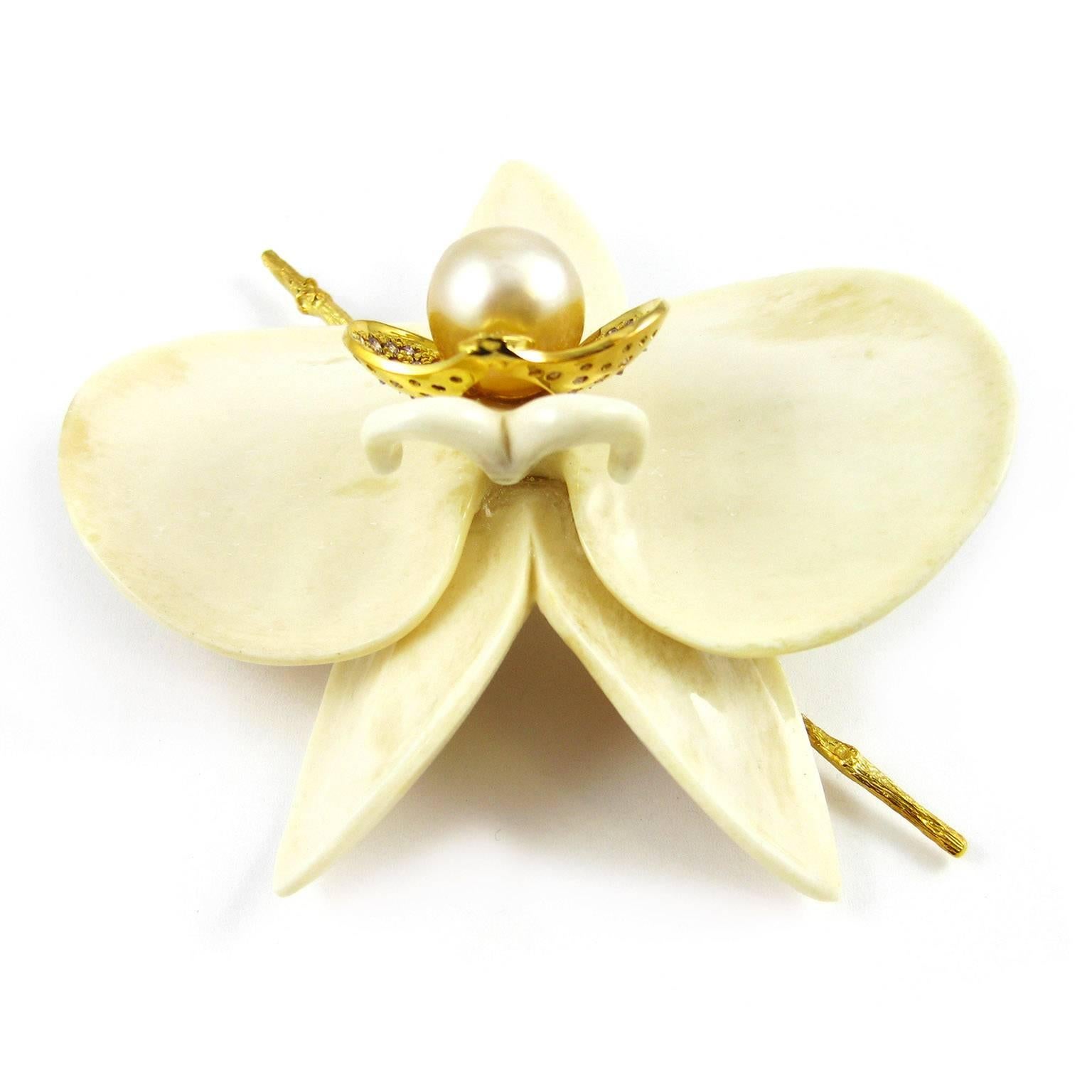 From the tropical garden of K. Brunini's Objects Organique collection comes this large orchid brooch blooming on an 18K gold twig. Each petal, made of polished and refined bone, gathers beneath a pillow of 18K yellow gold studded with approximately