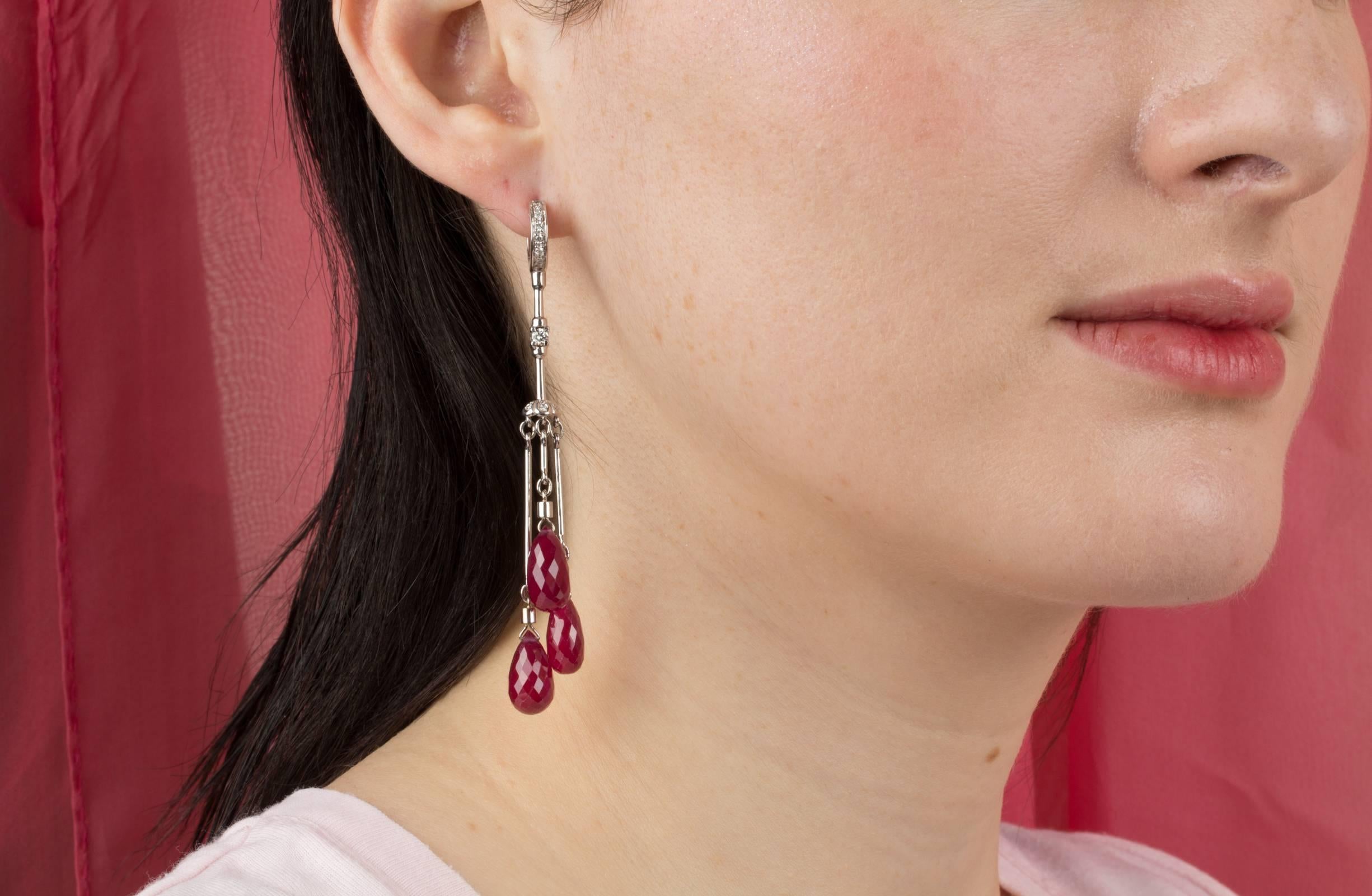 These ruby drop earrings feature 6 ruby briolettes for a total of approximately 42.50 carats in a playful and flexible design. The earring is complete with 0.40 carats of round diamonds of top quality (color, clarity and cut).
The earrings are