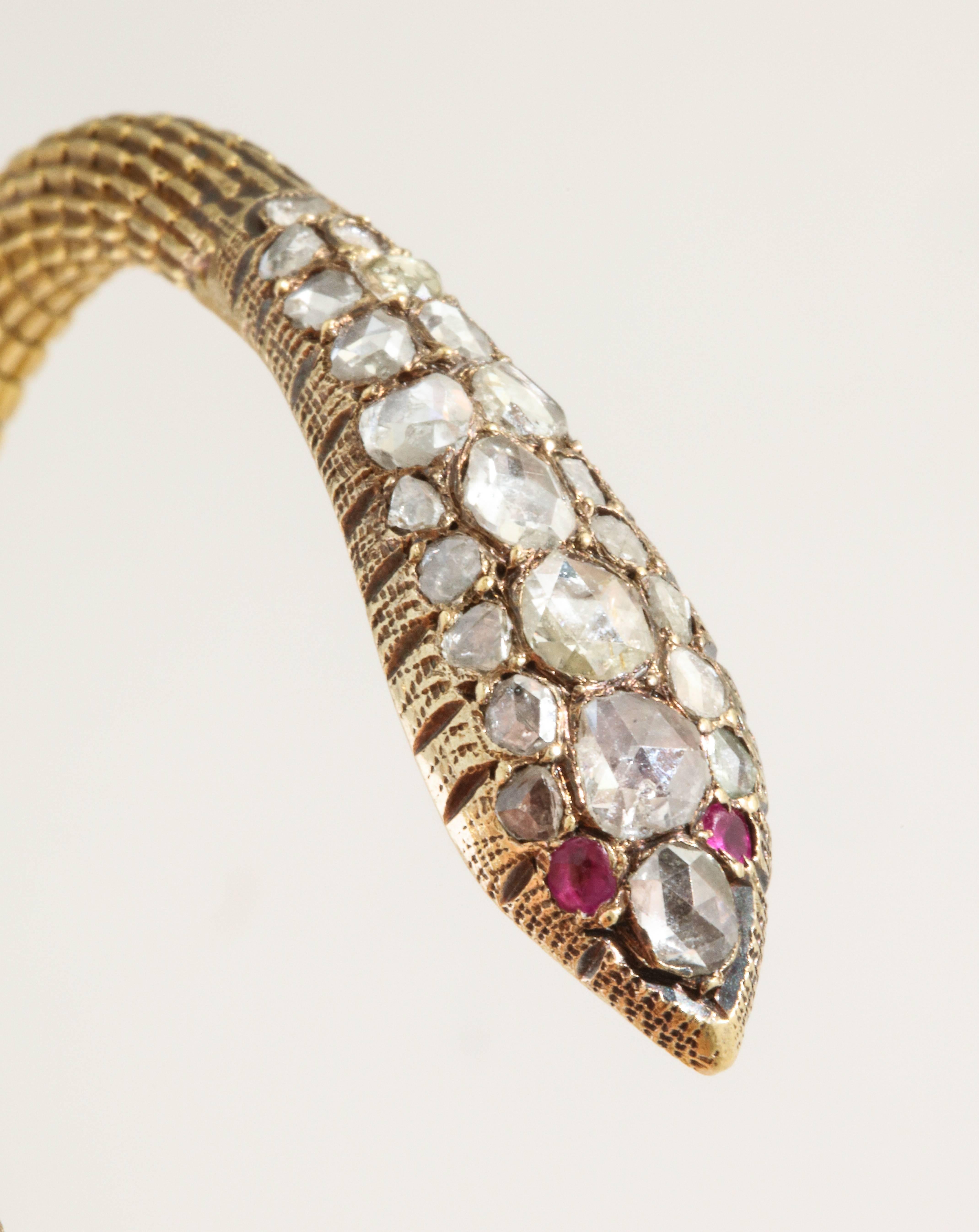 A pair of snake bangles featuring rose cut diamonds with a total estimated weight of 1.5 carats per bangle. The bracelets have an Arabic mark for 21 karat gold. Circa 1960s. Likely Syrian.