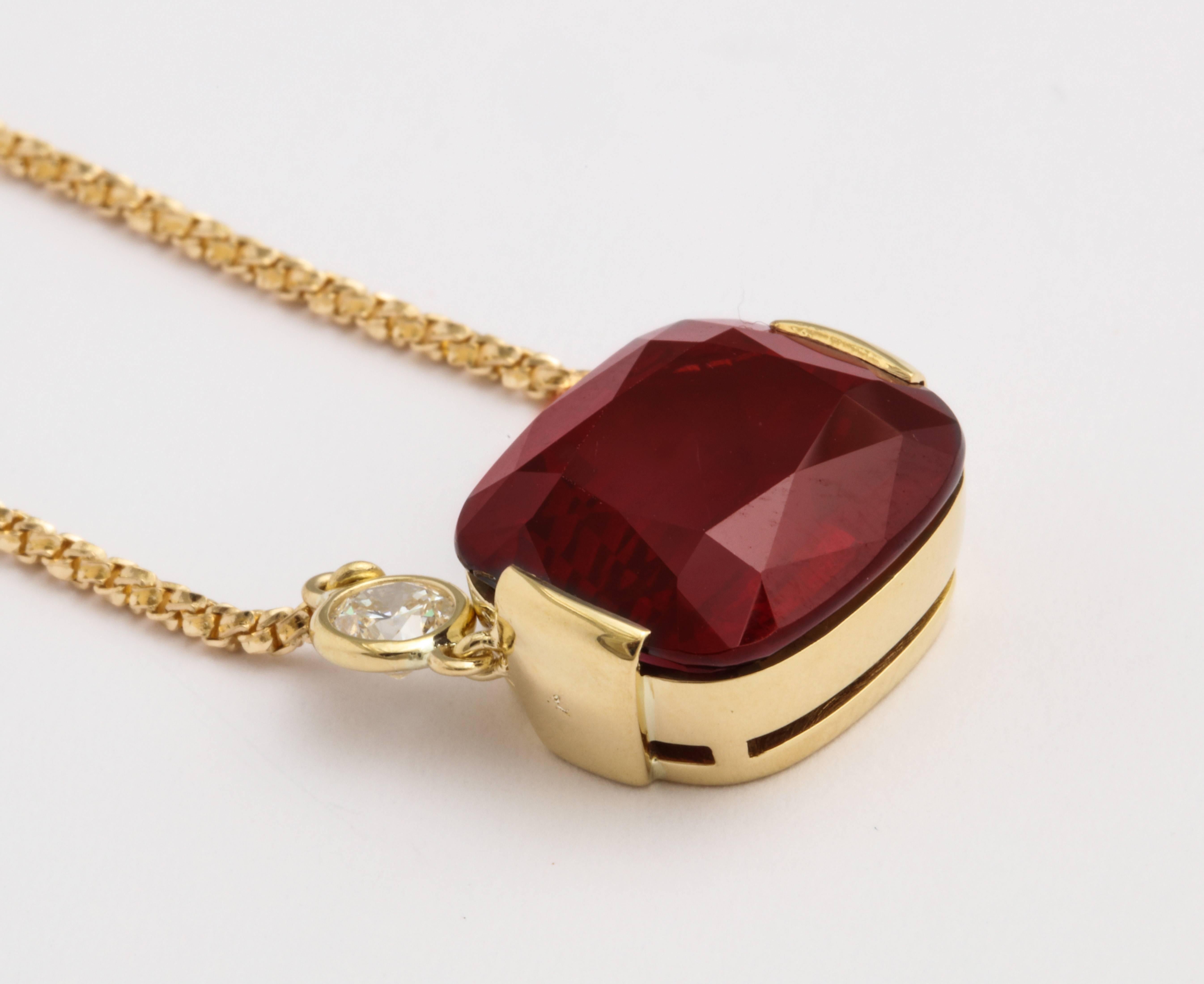 An 18 karat yellow gold box chain necklace featuring a cushion cut 16.65 carat rhodolite garnet. The round brilliant cut diamonds on either side weigh 0.83 carats total. Adjustable length - 20" or 16."

Signed Donna Vock Designs.
