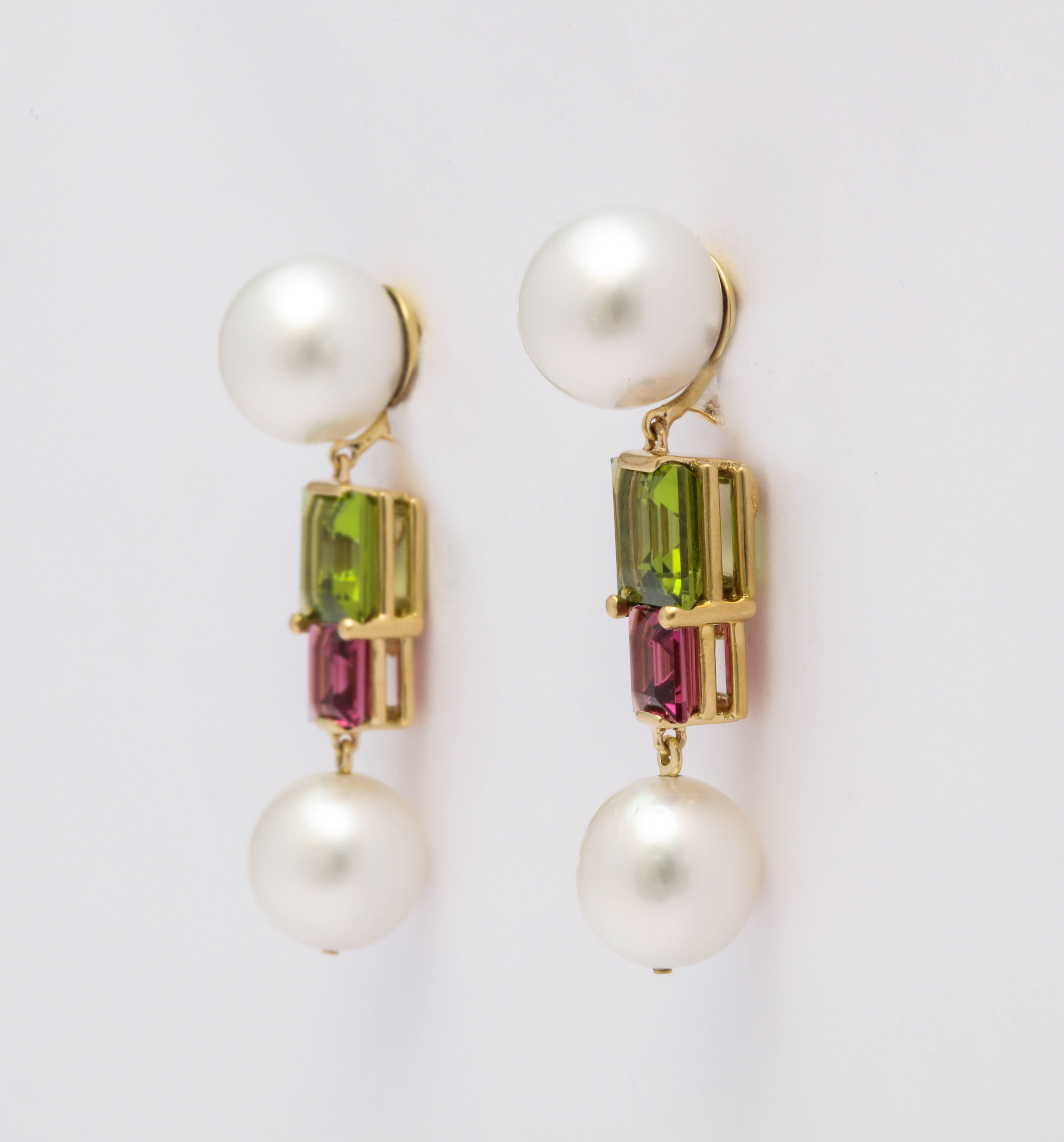A pair of 18 karat gold earrings with South Sea pearls, pink tourmaline and peridot. The emerald cut pink tourmalines weigh 2.11 carats total. The emerald cut peridots weigh 5.27 carats total. Signed DV

South Sea pearl measurements: 11.4, 11.3 /