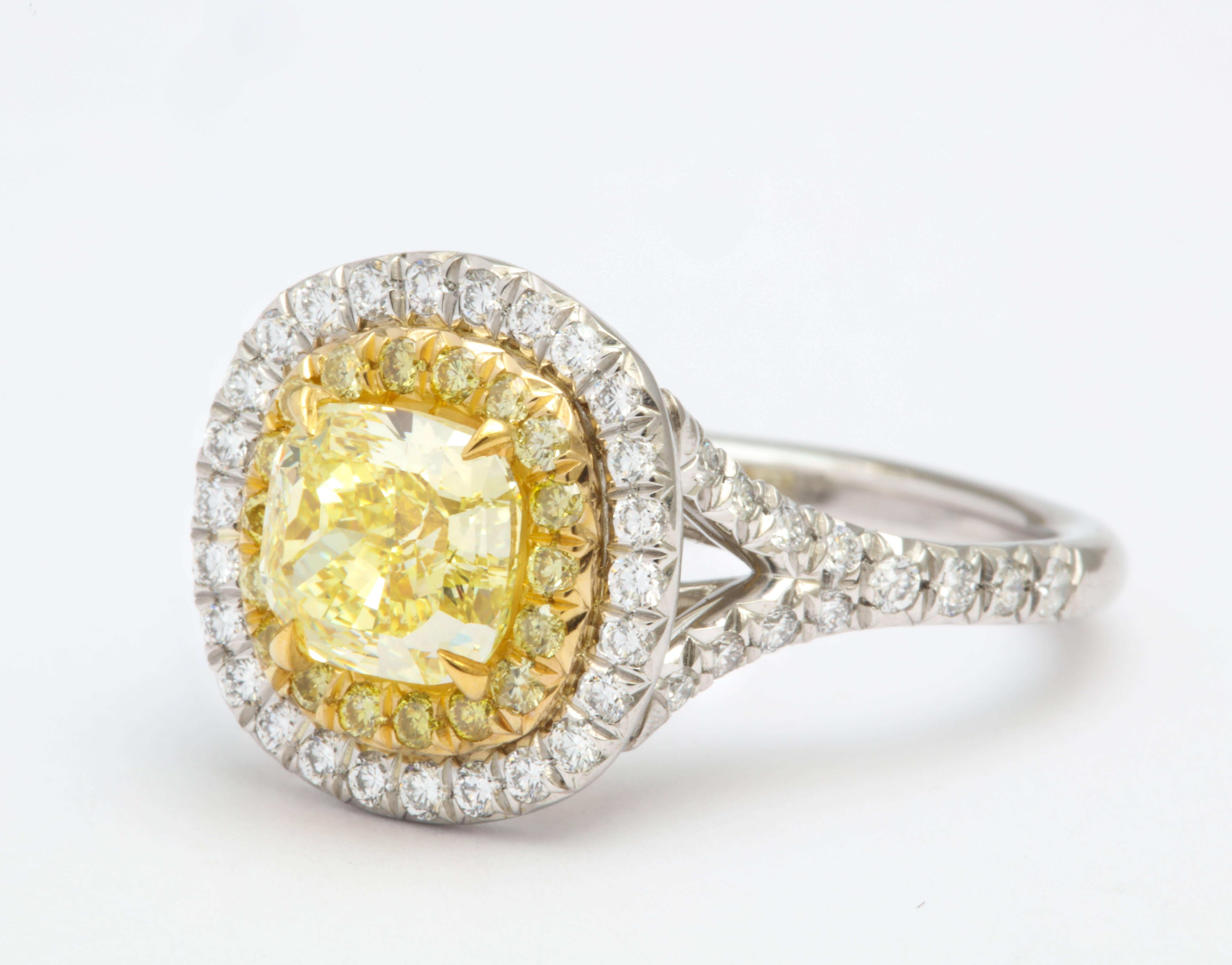 Fancy color engagement rings are on trend! Stand out with this beautiful, natural colored diamond ring featuring a 1.32 carat FANCY INTENSE yellow - VS1 GIA Certified diamond center stone, set in platinum and 18 karat yellow gold.  (GIA report