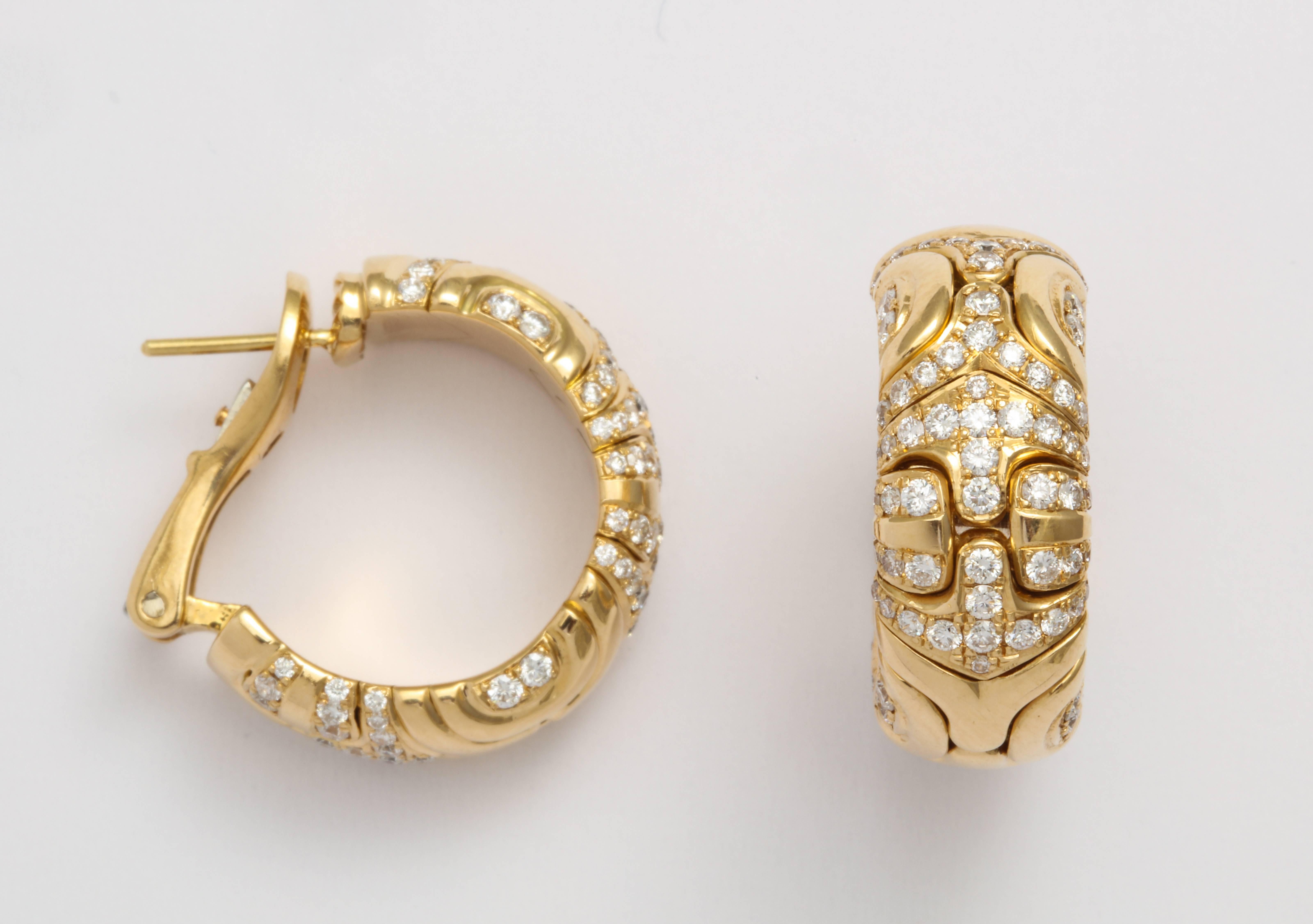 A pair of 18 karat yellow gold hoop earrings by Bulgari in the Parentesi style. A total diamond weight of approximately 3.36 carats. Made in Italy. Circa 1980s.
