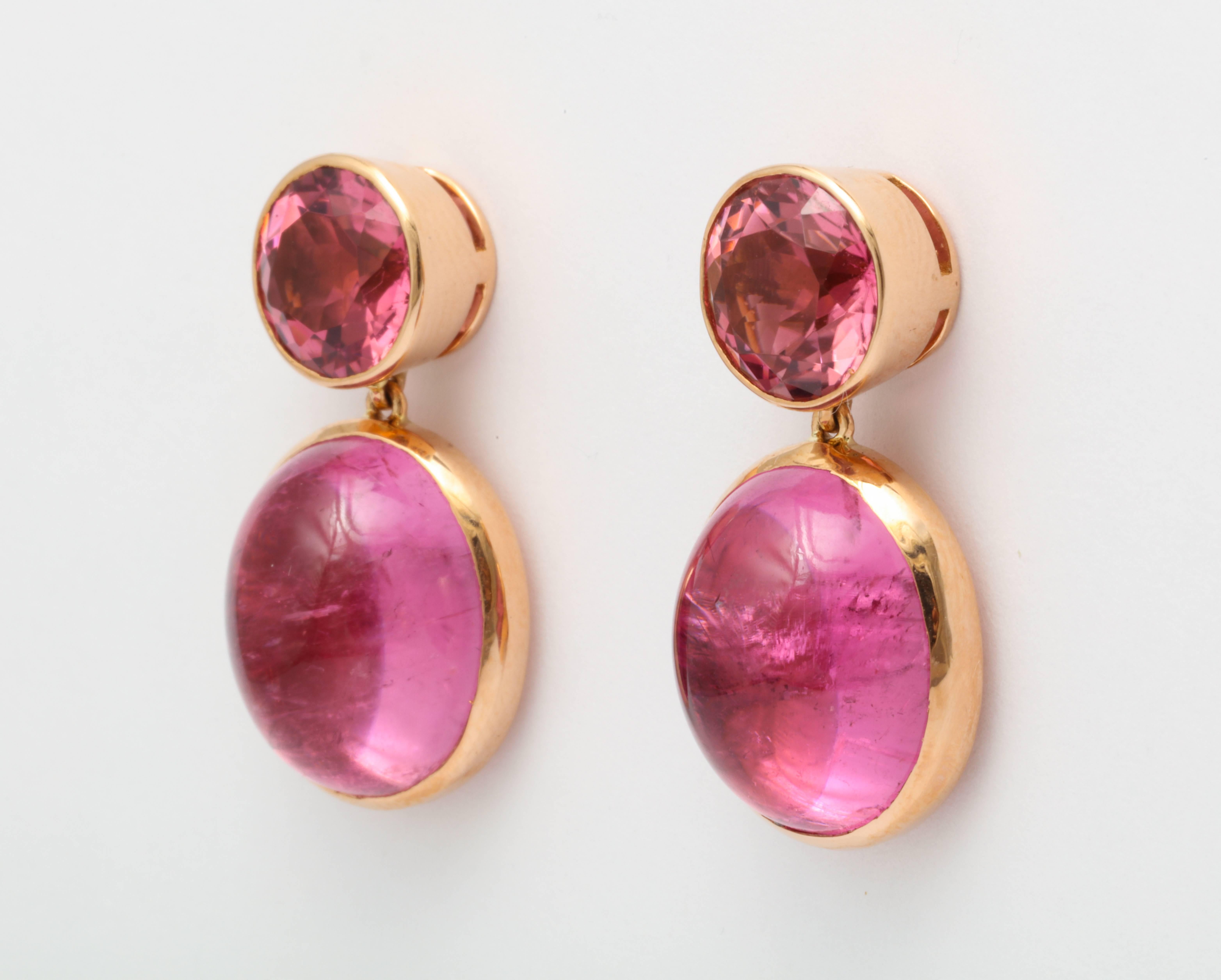 A pair of earrings set in 18 karat pink gold. Two round faceted pink tourmalines with a total weight of 5.68 carats. Two oval cabochon rubelites with a total weigh of 24.20 carats. Signed Donna Vock Designs. 