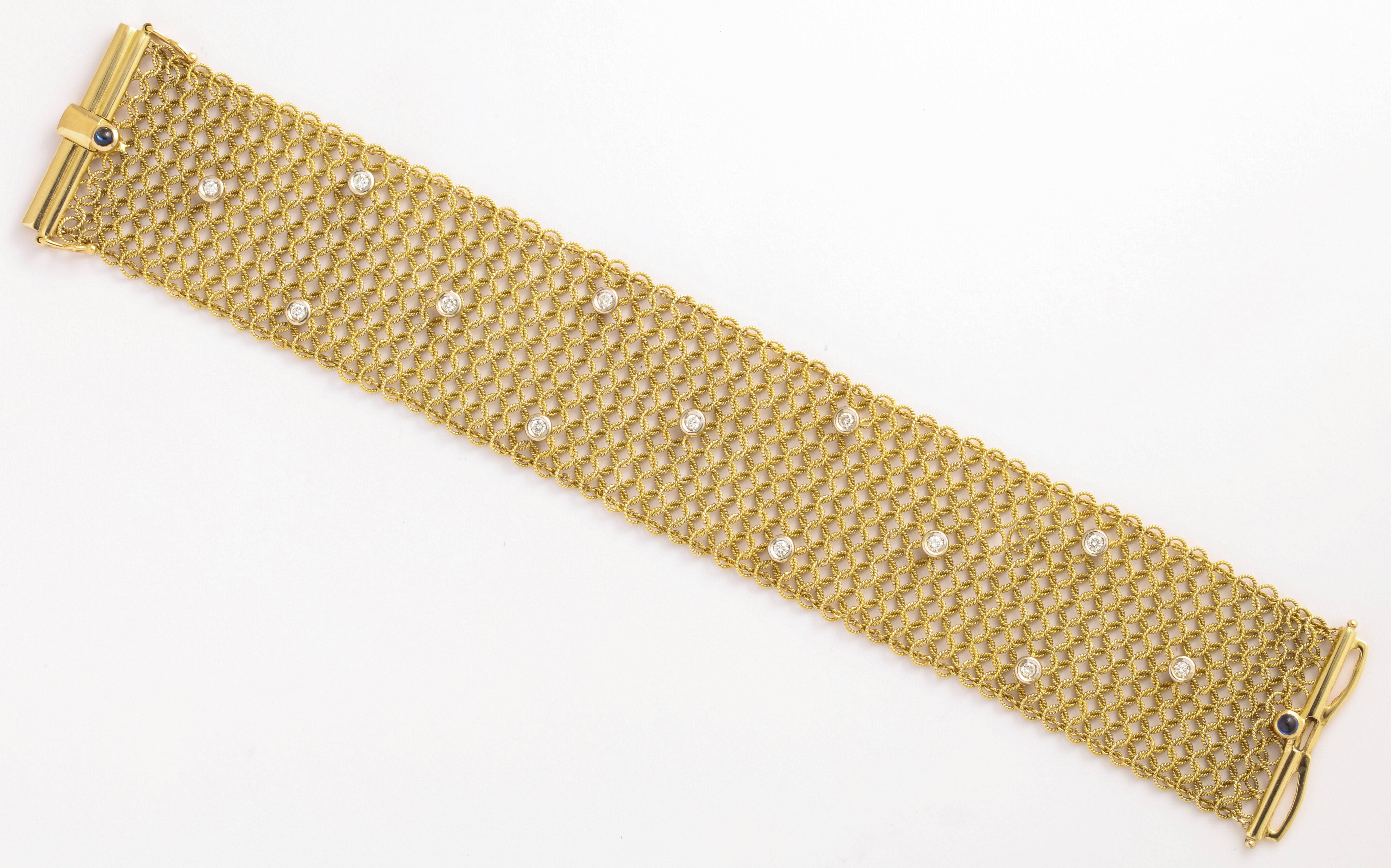 A woven 18 karat yellow gold bracelet set with round brilliant diamonds. Estimated diamond weight is 0.91 carats. Clasp set with two cabochon sapphires. Created by Tiffany and Co. 