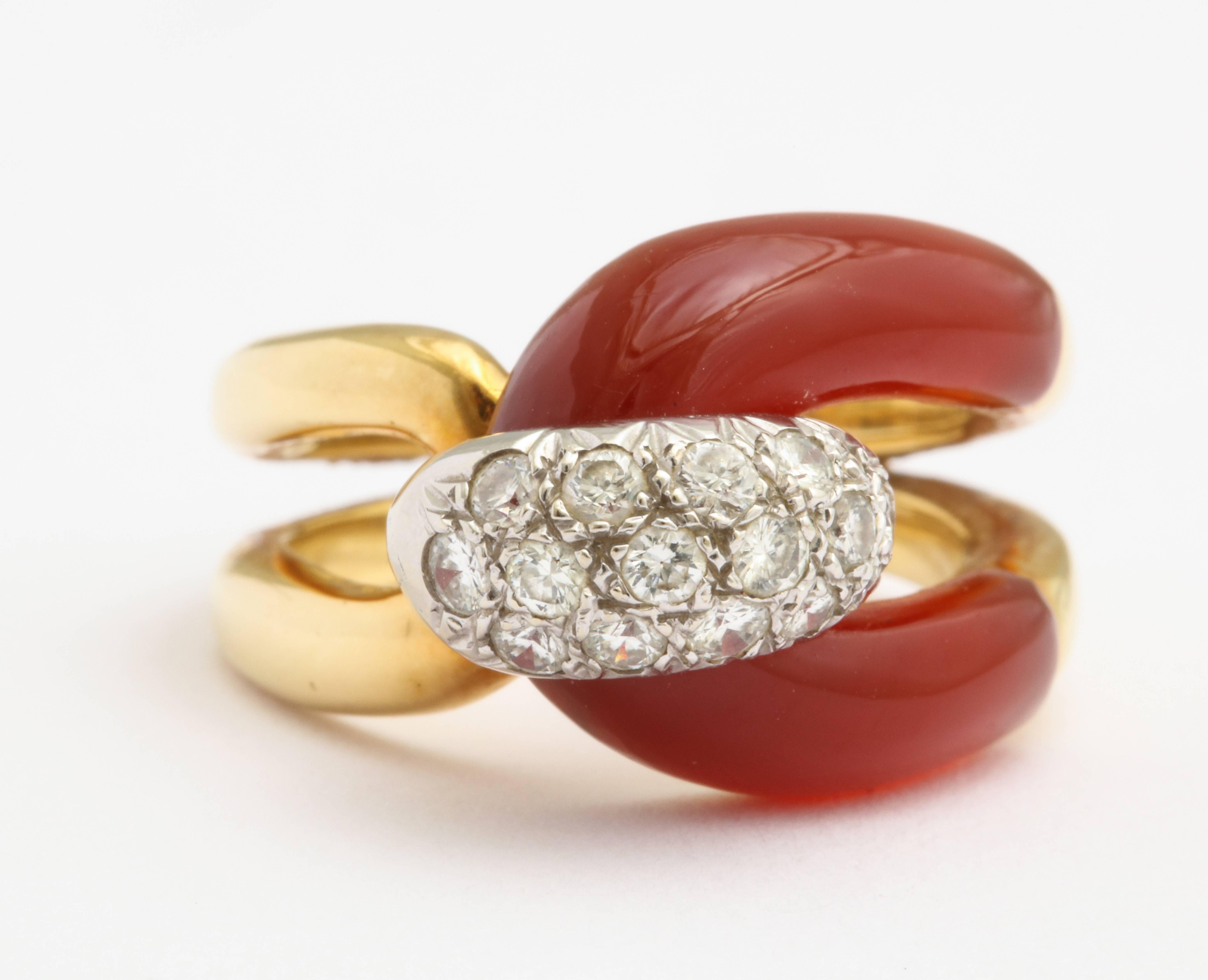 An 18 karat yellow gold ring featuring carnelian and diamonds. Estimated diamond weight is 0.48 carats total. Ring size 5.5.