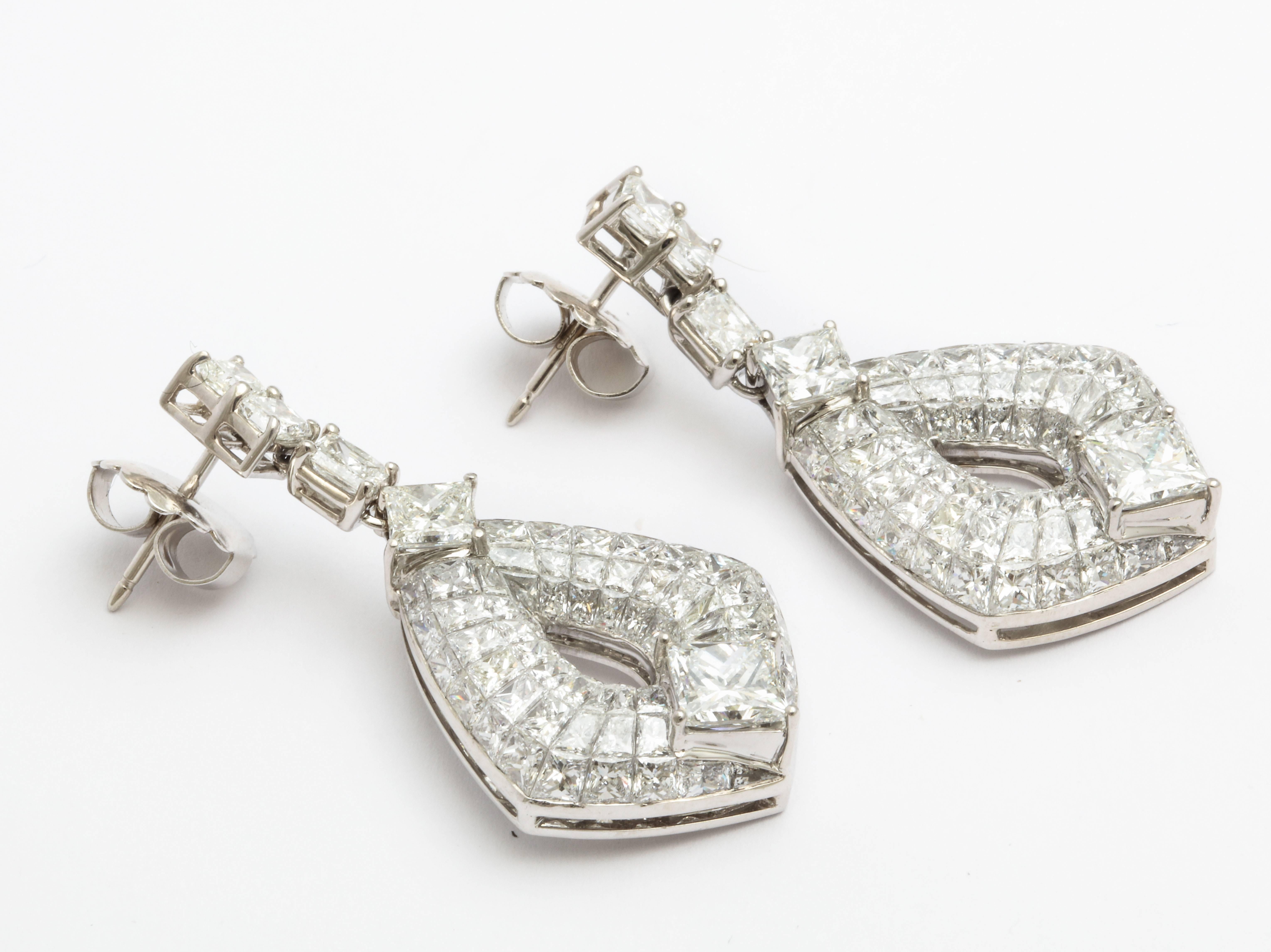 A pair of 18 karat white gold earrings featuring princess cut and quadrillion cut diamonds. Total estimated diamond weight of 12.66 carats. Diamonds range in clarity of VVS-VS and color of G-I.