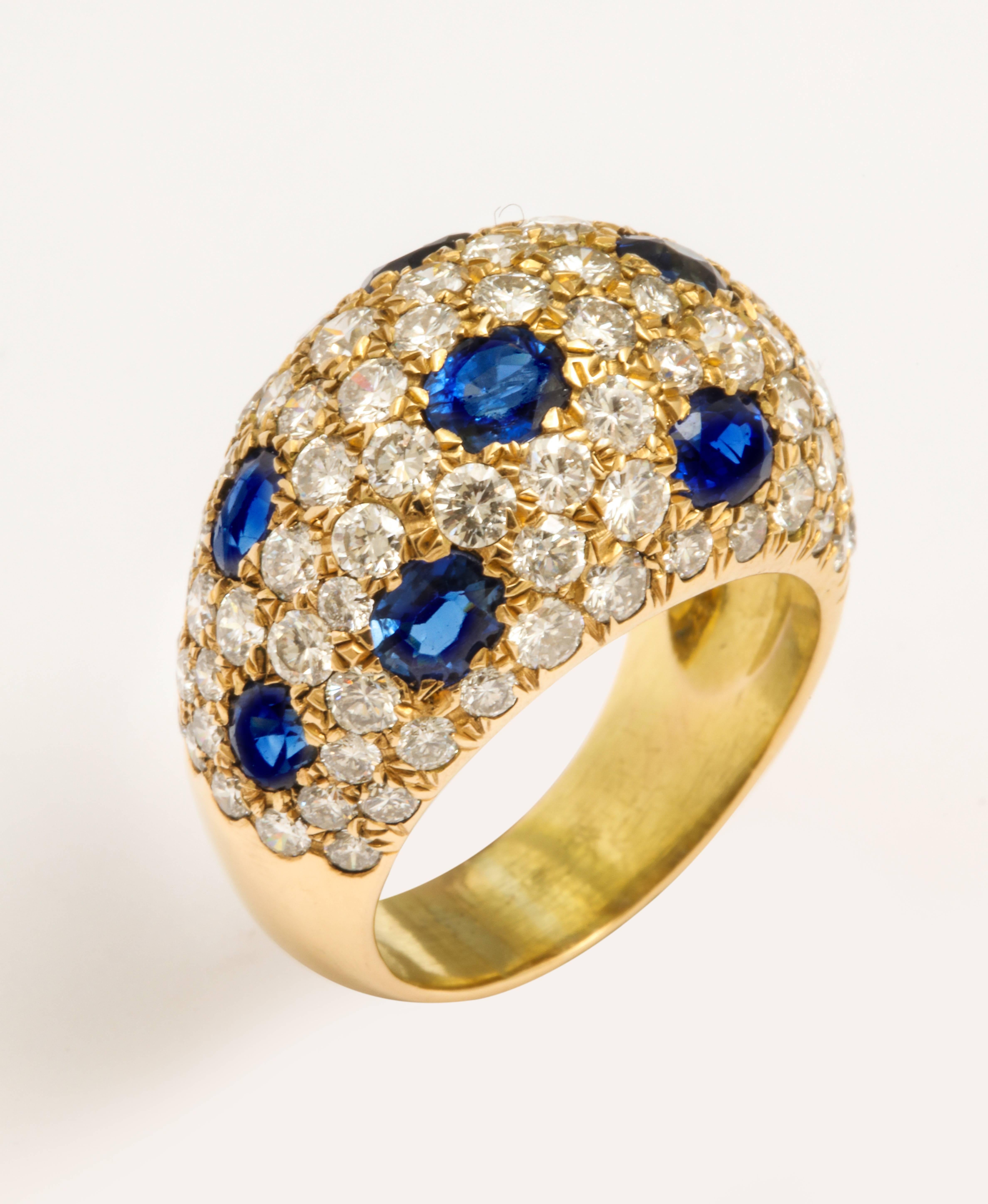 A super-stylish 18 karat yellow gold bombay ring pave set with round brilliant cut diamonds and oval sapphires. An estimated diamond weight of 4.00 carats and an estimated sapphire weight of 3.60 carats. Made in France with French marks. Circa