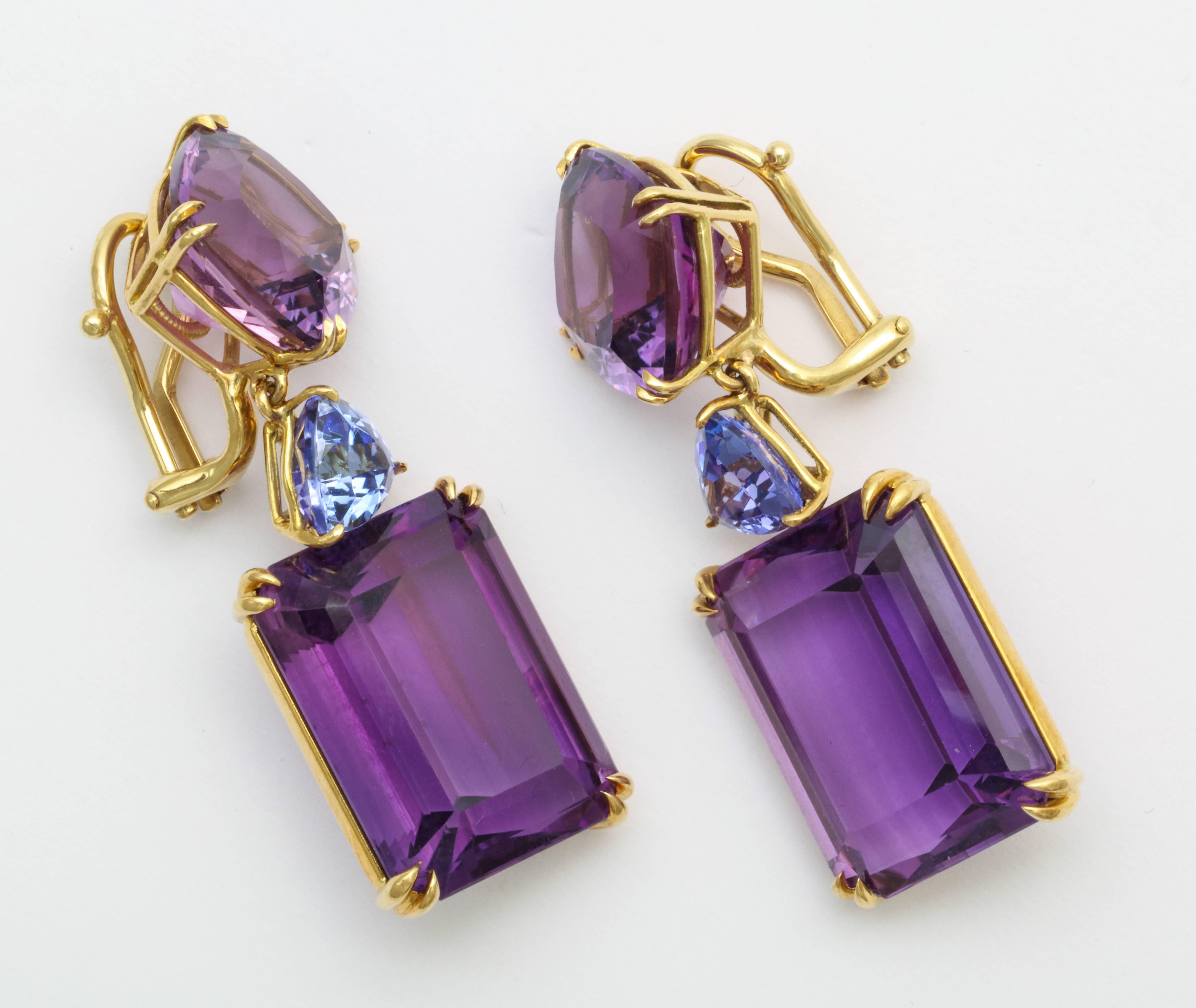 Beautifully crafted faceted emerald-cut and cushion cut amethyst of top quality, bright color are highlighted by a brilliant medium blue tanzanite transition stone. 4 amethysts weigh a total of over 52 carats with 2 tanzanites weighing a total of