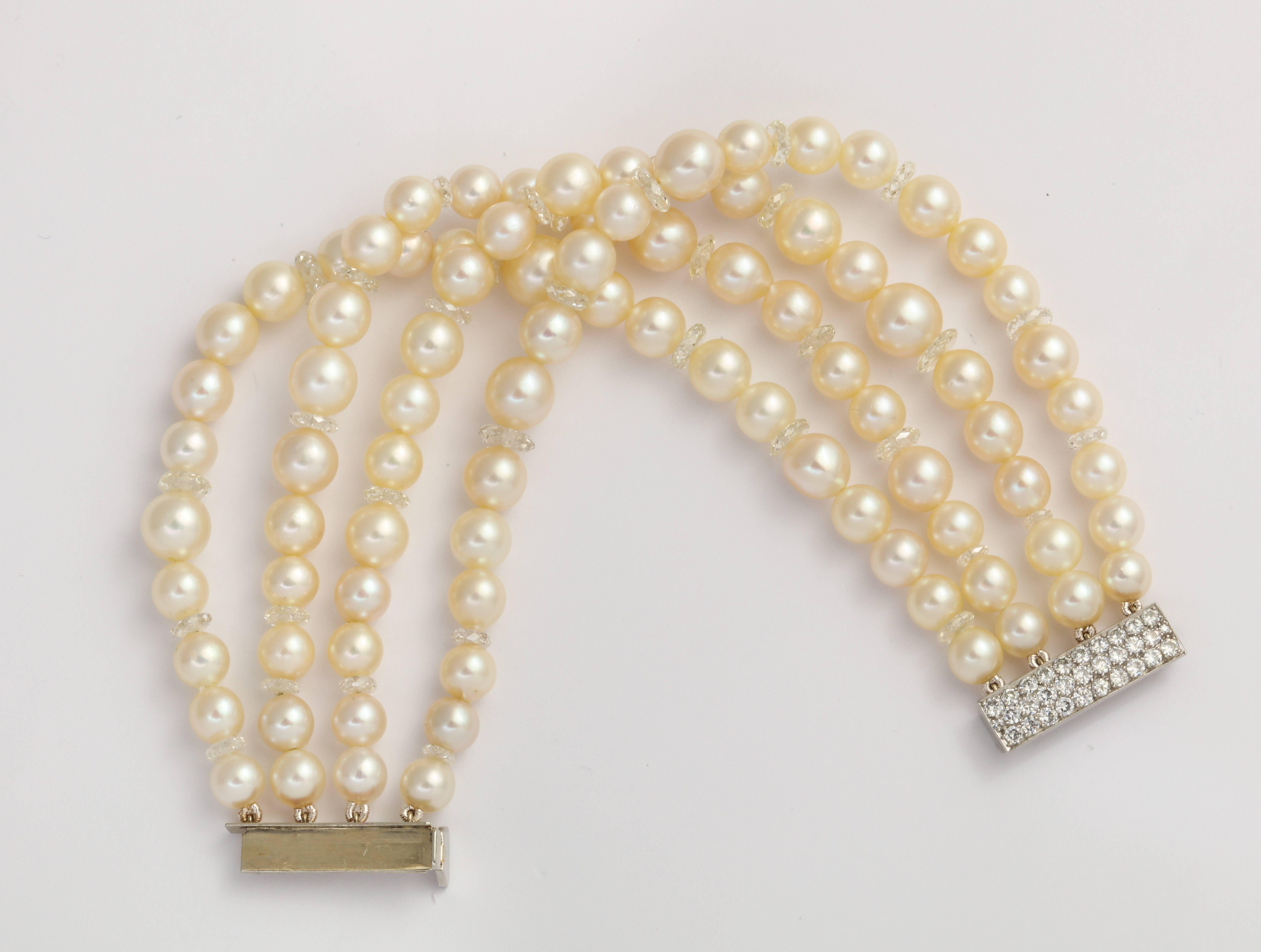 A 4-row bracelet featuring cultured pearls, interspersed with disc shaped diamonds weighing a total of 19.5 carats. Set with an 18 karat white gold and diamond clasp with a total diamond weight of 1.45 carats estimated. The pearls range in size,