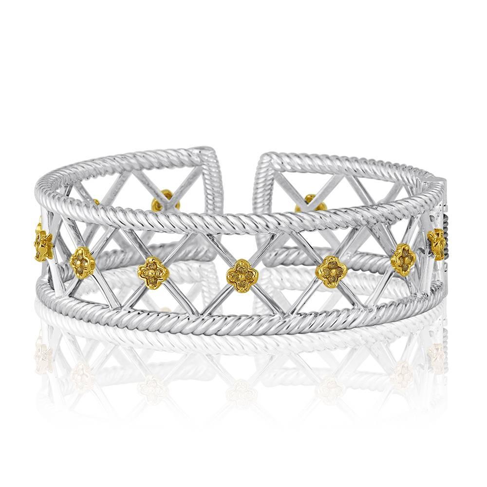 Exclusively from Design By Vatche, Honey Collection
Beautifully hand crafted 14 karat green gold and sterling silver with yellow diamonds on flowers. This cuff bracelet opens with a spring claps for a secure and easy wear.
Diamonds: .52 carat total