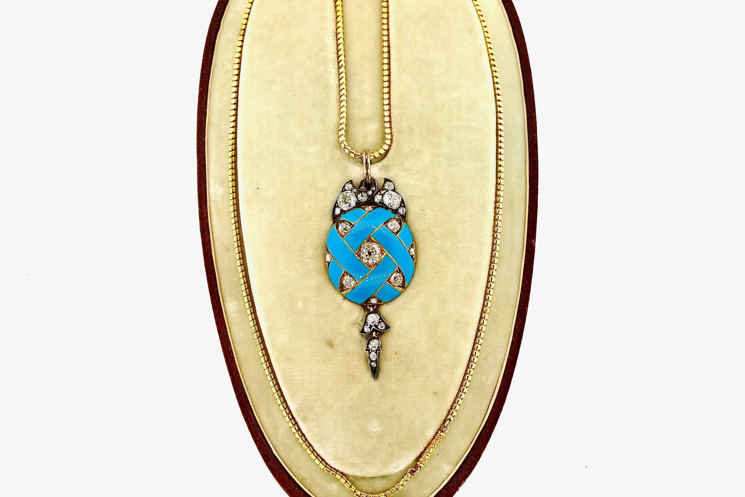 Bright robins egg blue enamel makes this pendant pop.  The enamel makes a design like a basketweave with old cut diamonds set between the weave.  Additionally diamond leaves accent the top of the pendant and a dart of diamonds hang from the bottom. 