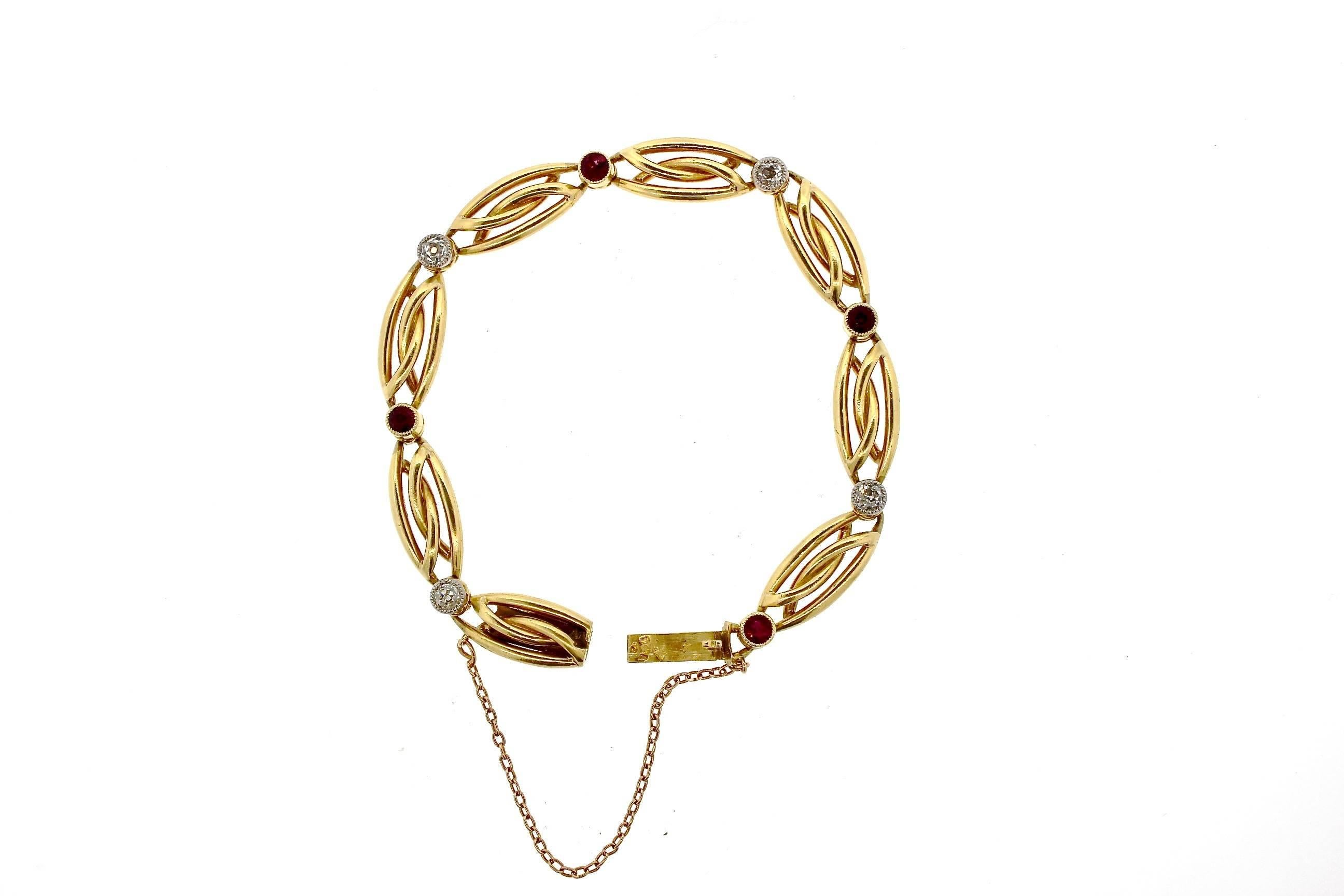 This charming antique bracelet features a sleek entwined link with alternating collet set ruby and diamonds.  Four round cut rubies weigh approximately .40 cts., and similarly 4 old cut diamonds weigh approximately 0.40 cts.  The bracelet is made in