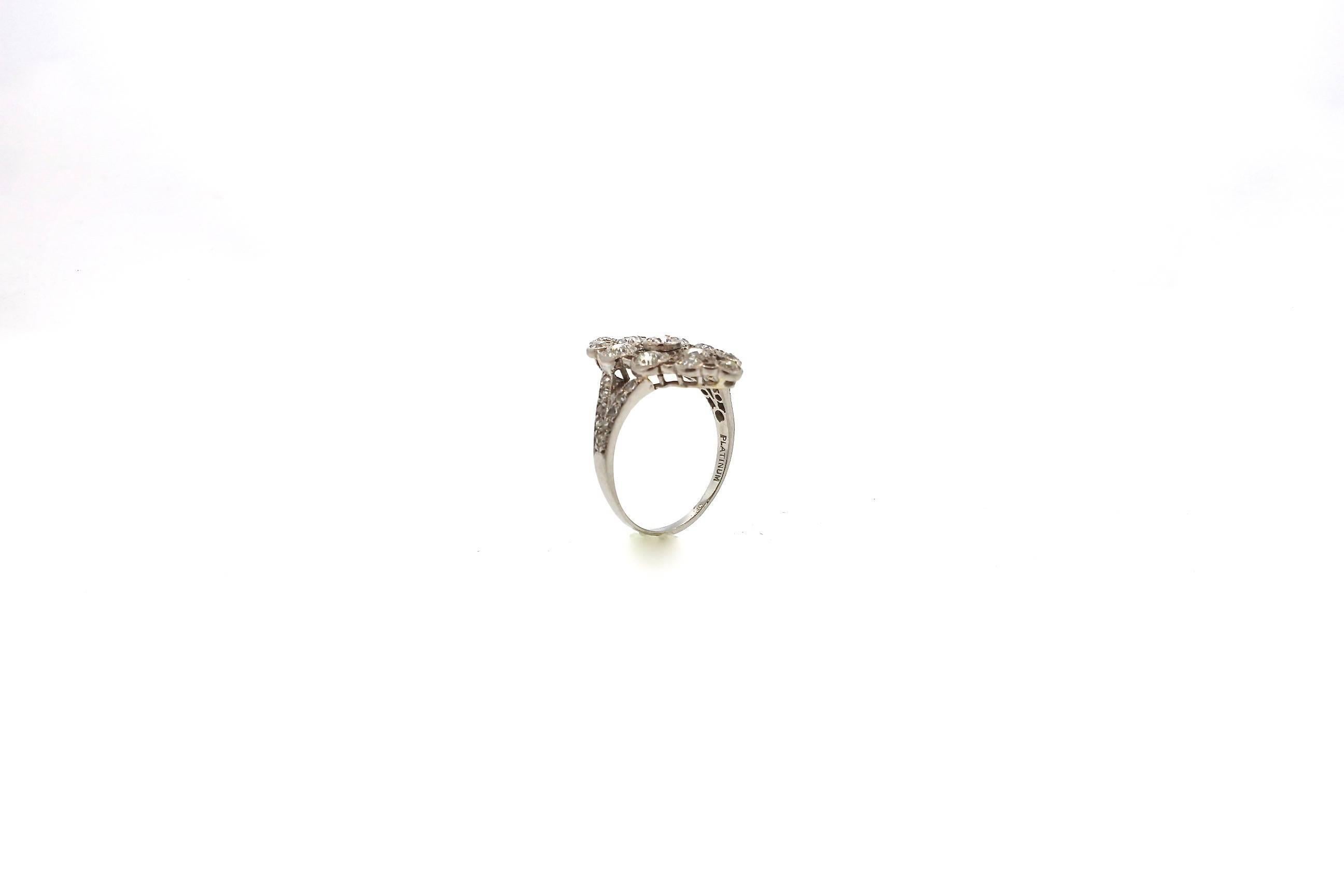 A beautiful Edwardian open navette shaped diamond ring circa 1910. Perfect for a right hand ring or avant-garde engagement ring. Bezel set old European cut diamonds are connected by milgrained bars. Thirteen old European cut diamonds weigh