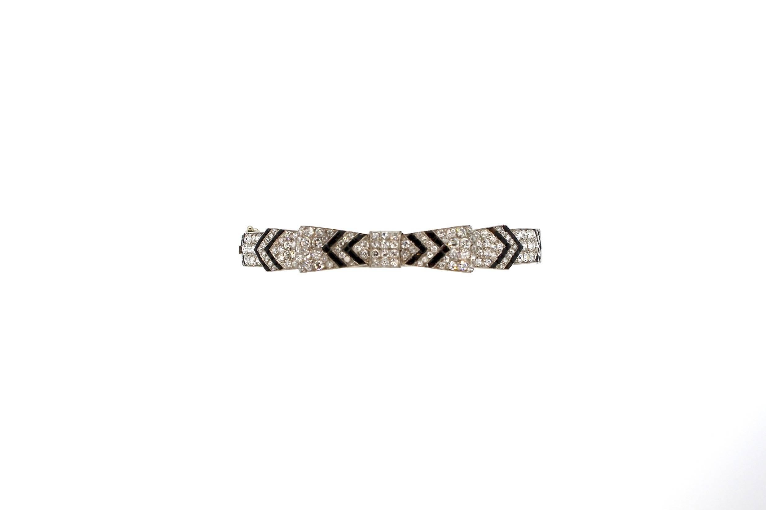 Antique Art Deco Diamond Onyx Platinum  Bow Bangle Bracelet In Good Condition In New York, NY