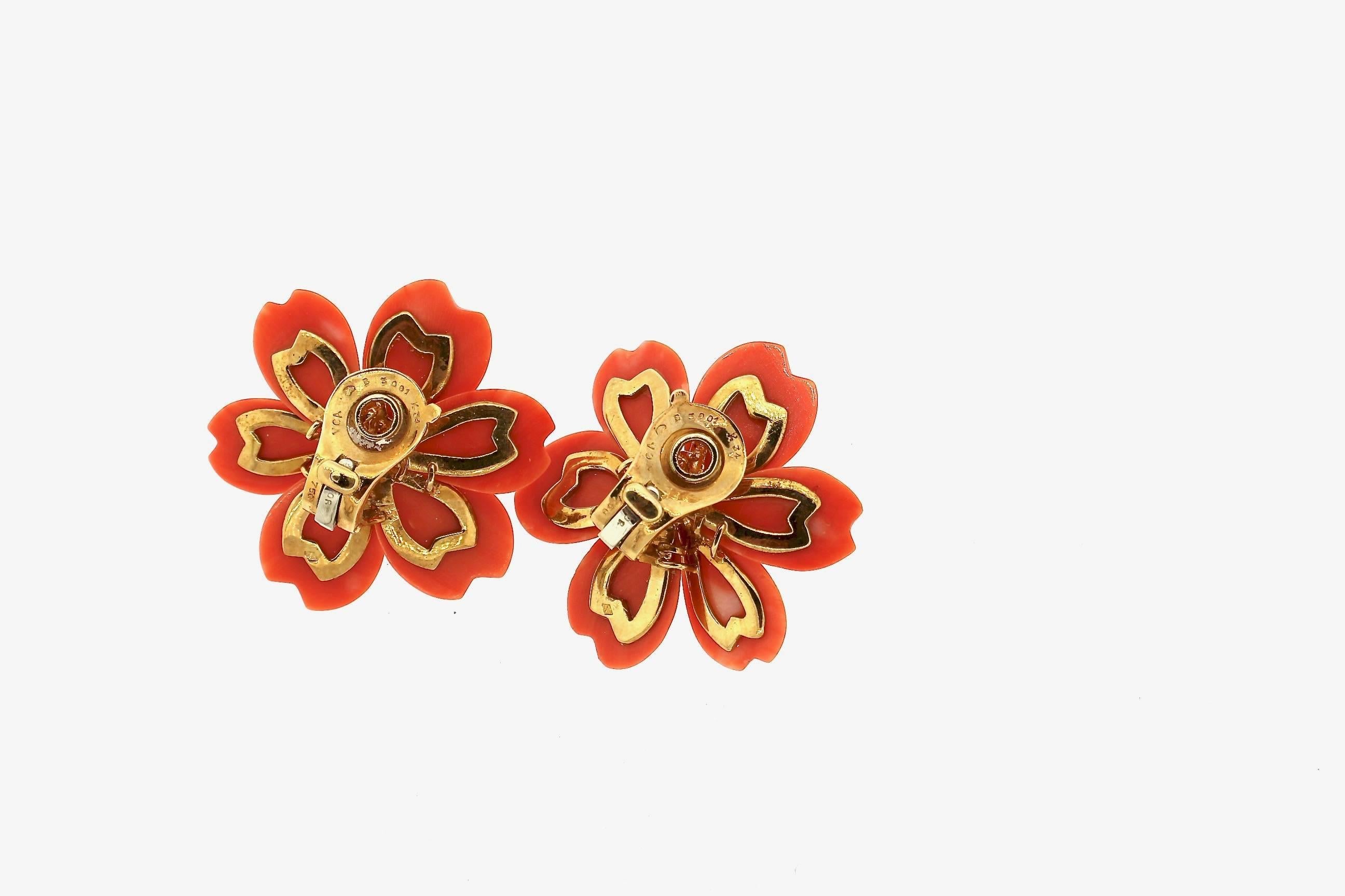 Classic and timeless, these vintage large size Rose De Noel red coral diamond earrings by Van Cleef & Arpels are a staple.  The hue of the coral and dark and near red.  The earrings are set with 12 round brilliant diamonds weighing about a carat